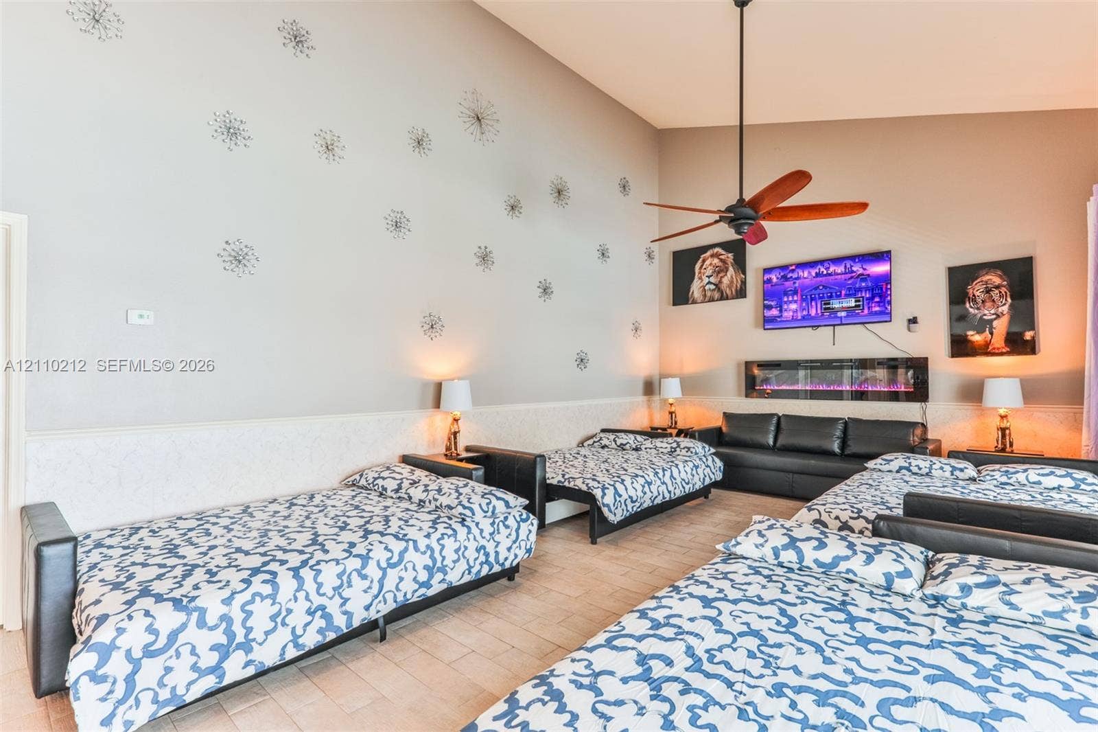 407 SW 37, Cape Coral, FL 33914 Vaulted ceilings featuring a central ceiling fan and a wall-mounted electric fireplace