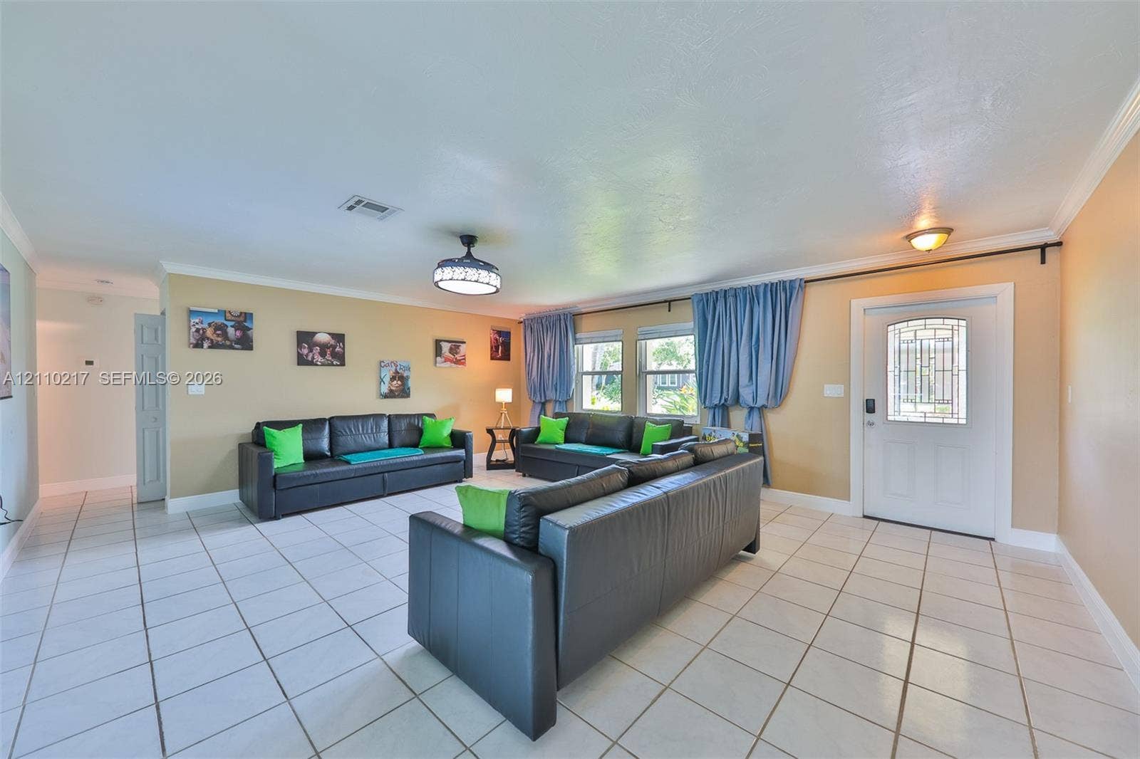 503 SW 17 Street, Cape Coral, FL 33990 Spacious interior featuring large-format white tile flooring, recessed lighting, a modern ceiling fan with integrated lighting, and an entry door with decorative glass paneling