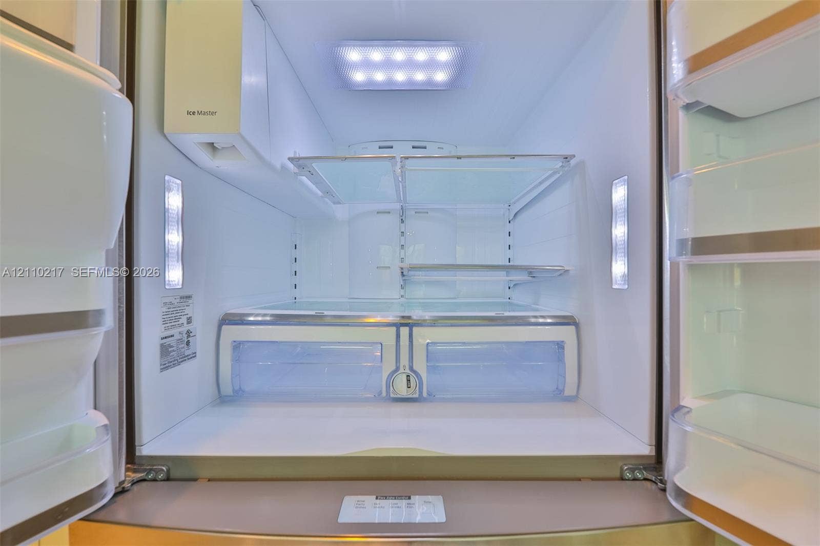 503 SW 17 Street, Cape Coral, FL 33990 Stainless steel refrigerator featuring integrated LED interior lighting, adjustable glass shelving, dedicated climate-controlled storage drawers, and an in-door ice dispensing system
