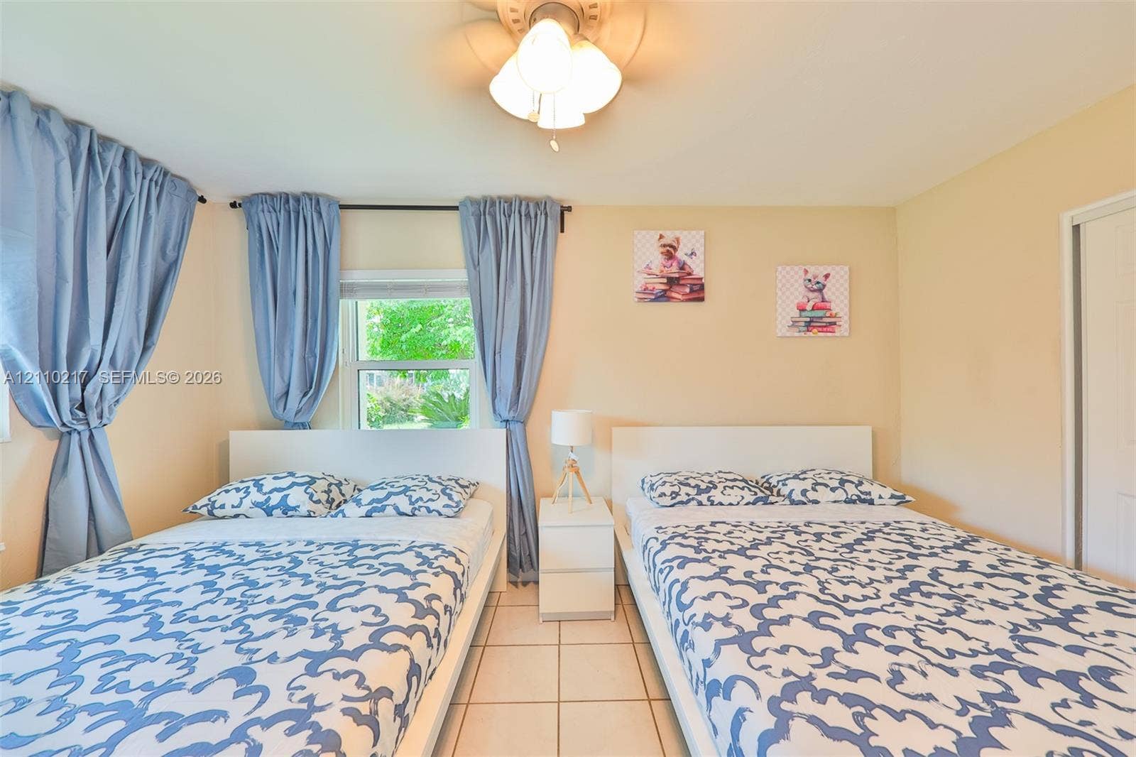 503 SW 17 Street, Cape Coral, FL 33990 Room featuring neutral-toned walls, tiled flooring, a multi-light ceiling fixture, and a window with a curtain rod assembly
