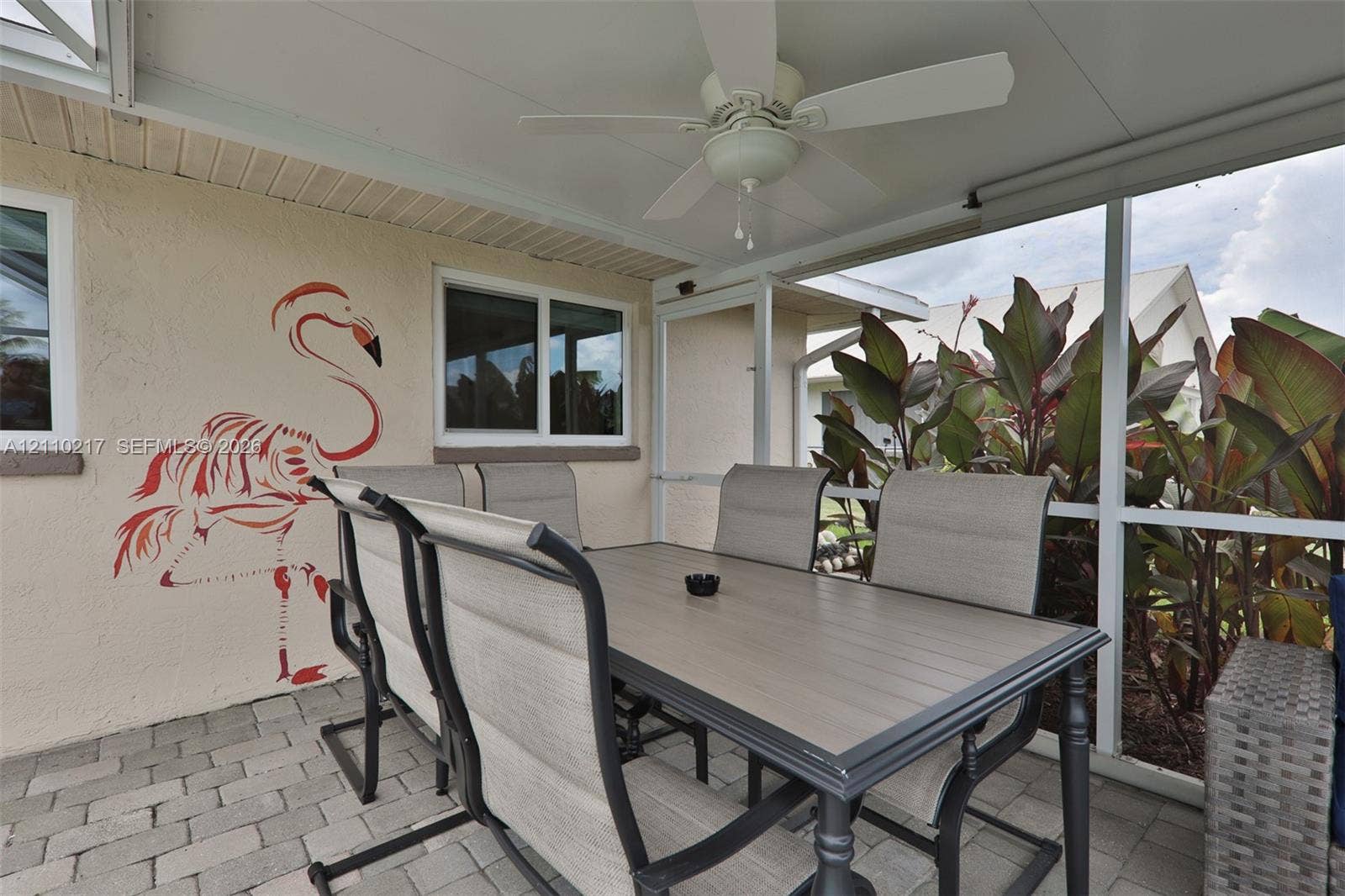 503 SW 17 Street, Cape Coral, FL 33990 Screened-in patio featuring paver flooring, a white ceiling fan, and a covered roof structure