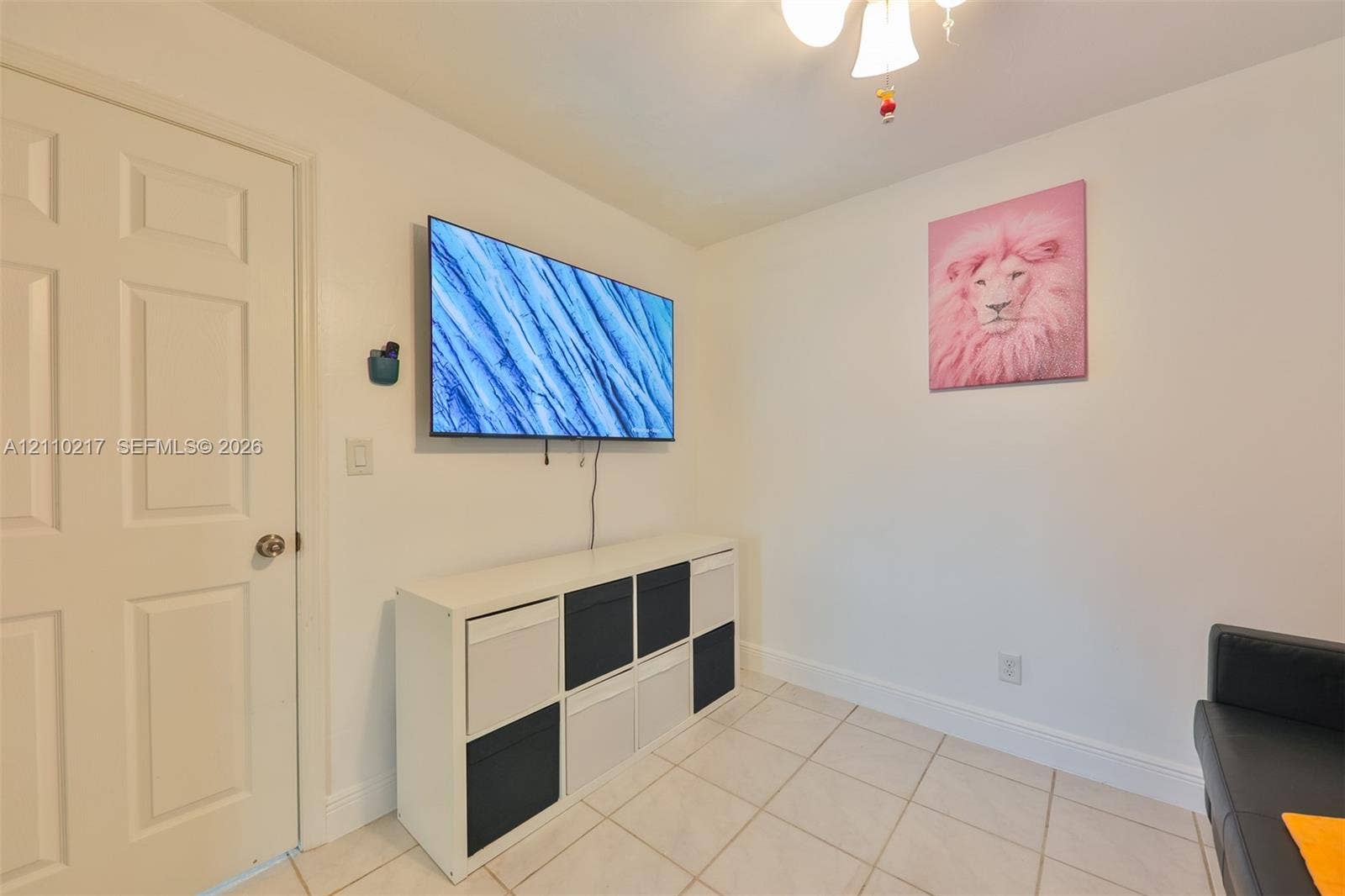 503 SW 17 Street, Cape Coral, FL 33990 Ceramic tile flooring, white interior walls, solid-core interior door, and multi-arm ceiling fixture