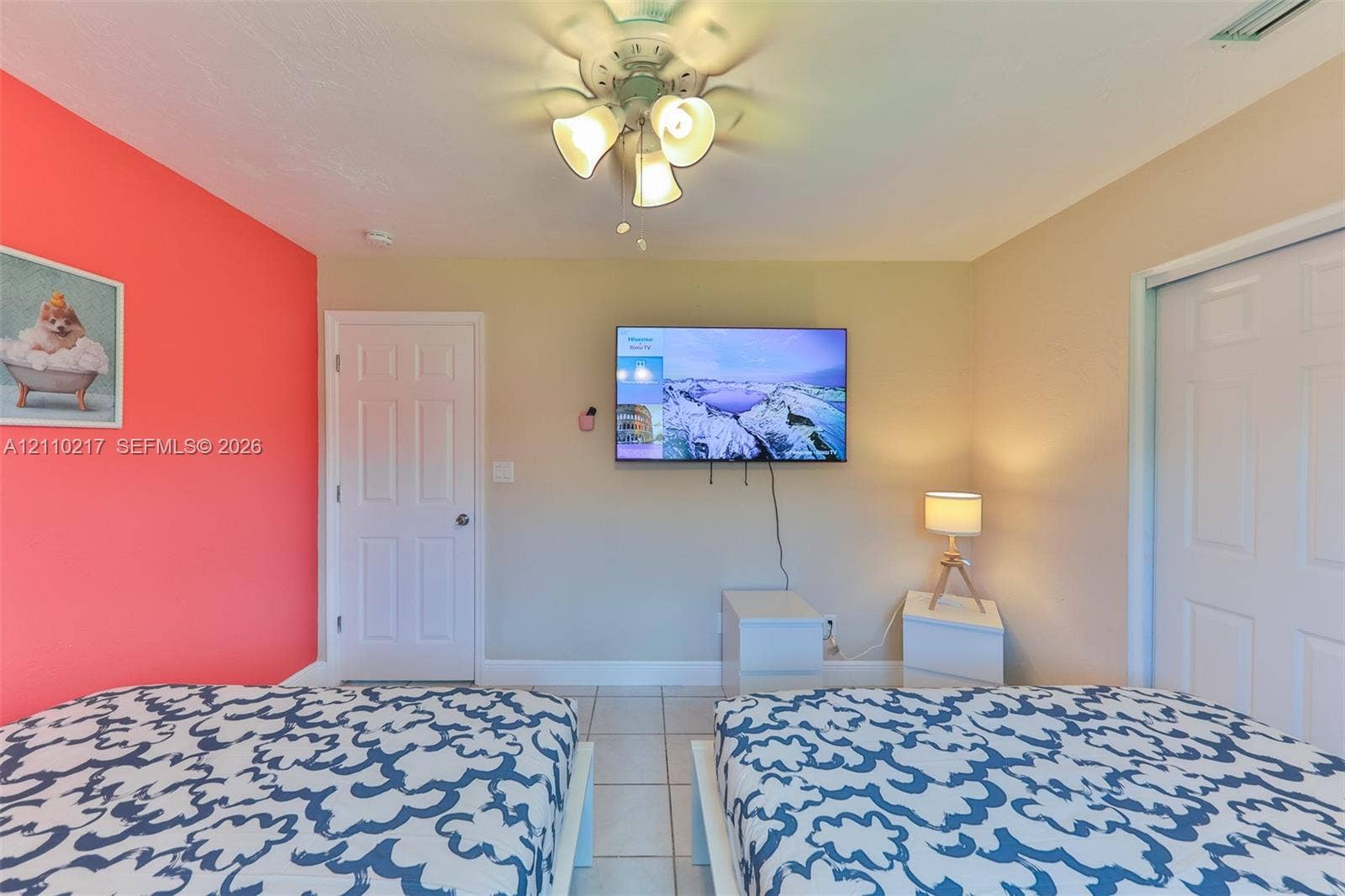503 SW 17 Street, Cape Coral, FL 33990 Interior space featuring light-colored tile flooring, a multi-light ceiling fan, and six-panel interior doors
