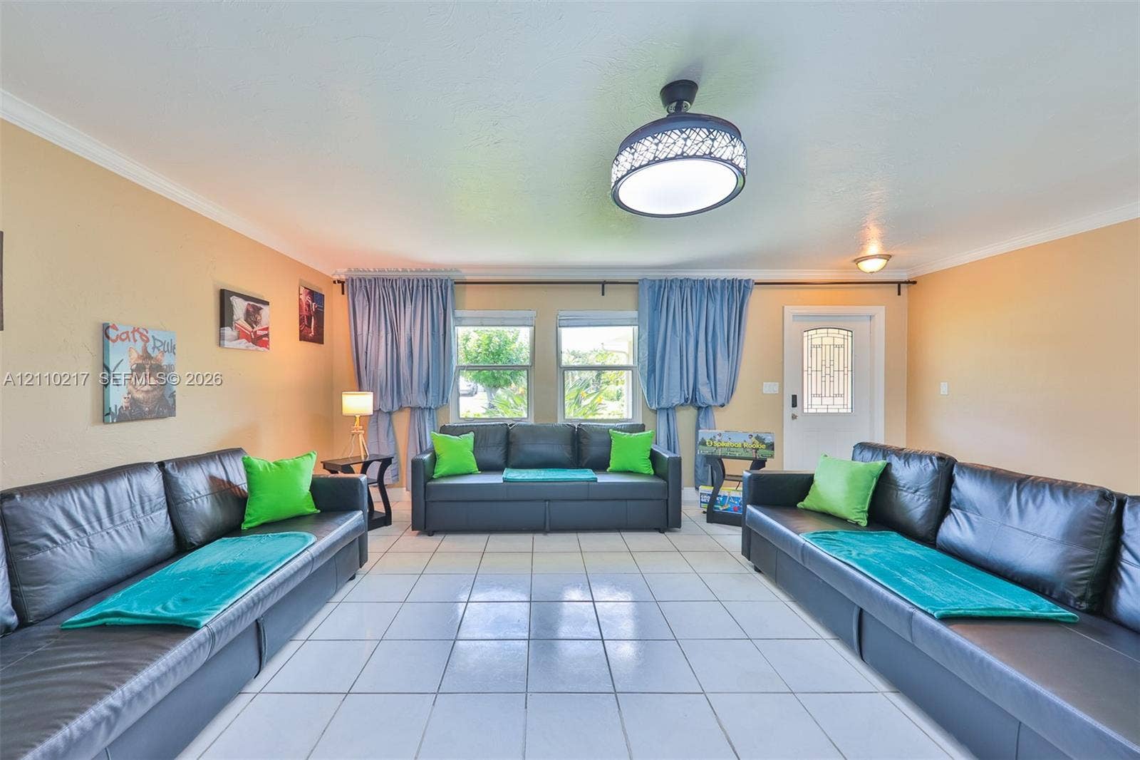 503 SW 17 Street, Cape Coral, FL 33990 Living area featuring tile flooring, a decorative dome ceiling light fixture, and an exterior door with decorative glass paneling