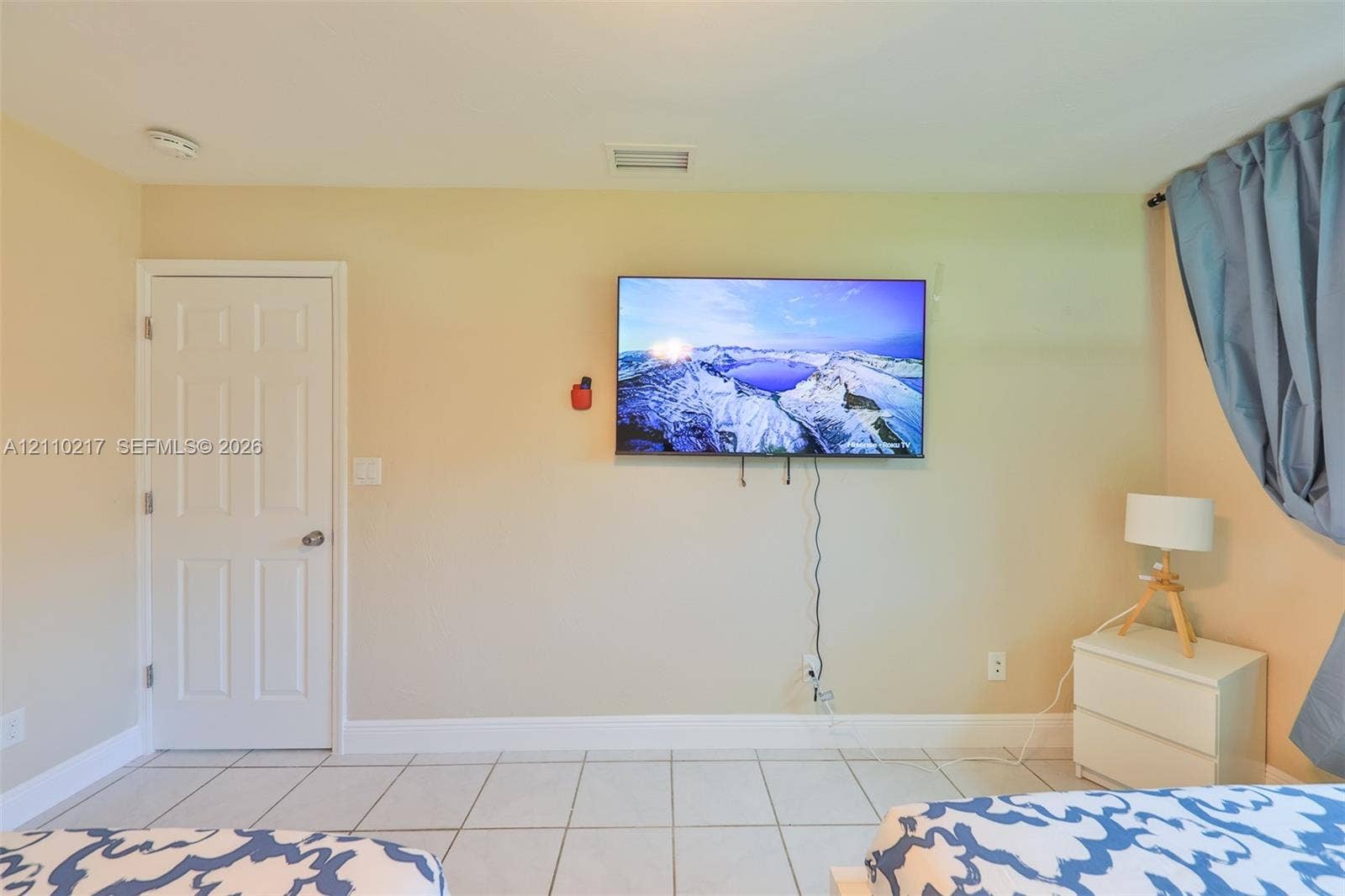 503 SW 17 Street, Cape Coral, FL 33990 Interior space featuring large-format ceramic tile flooring and a solid-core interior door with brushed nickel hardware