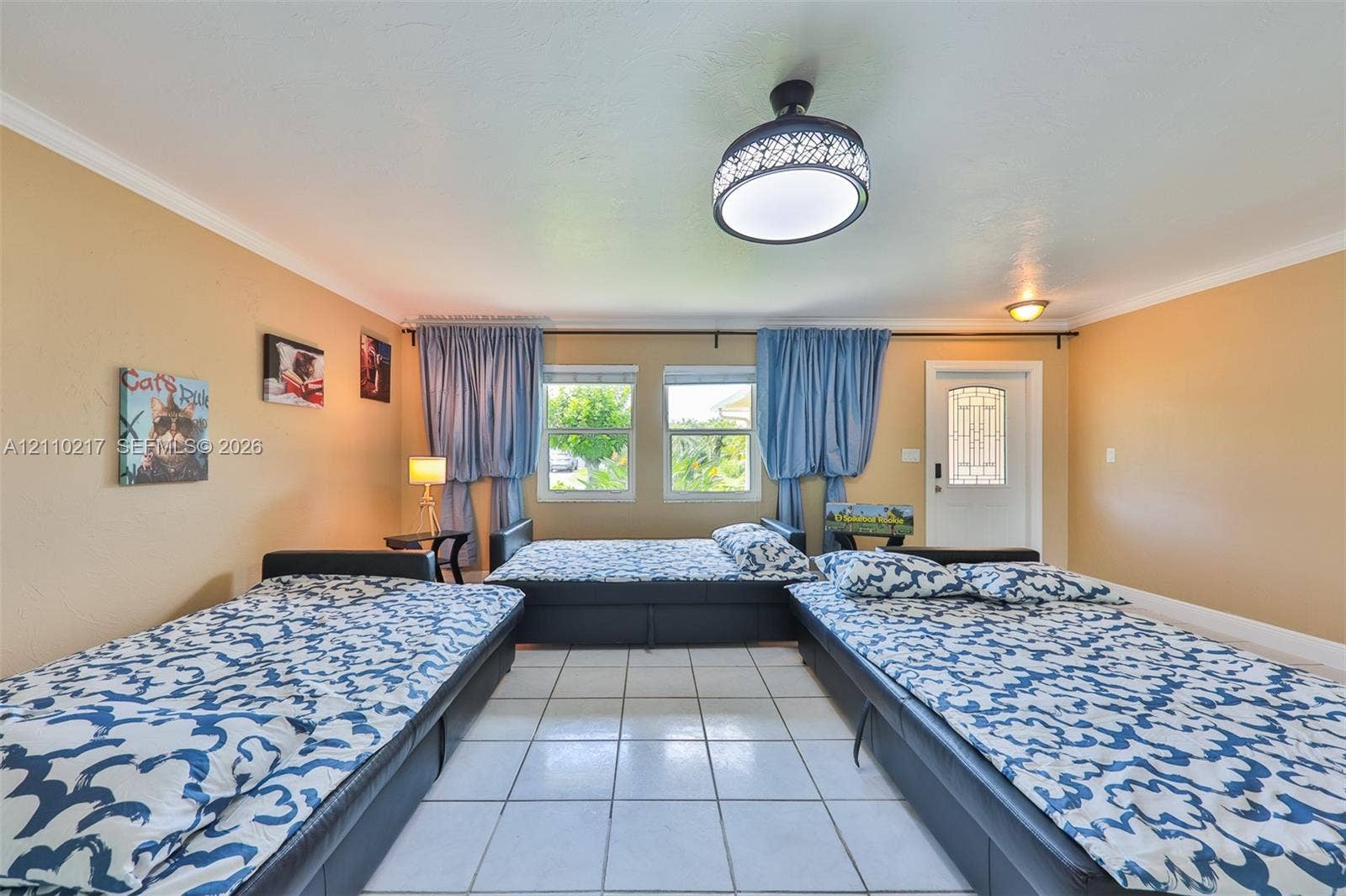 503 SW 17 Street, Cape Coral, FL 33990 Tiled flooring, dual windows with curtain hardware, flush-mount decorative ceiling lighting, and an exterior door with a glass inlay panel