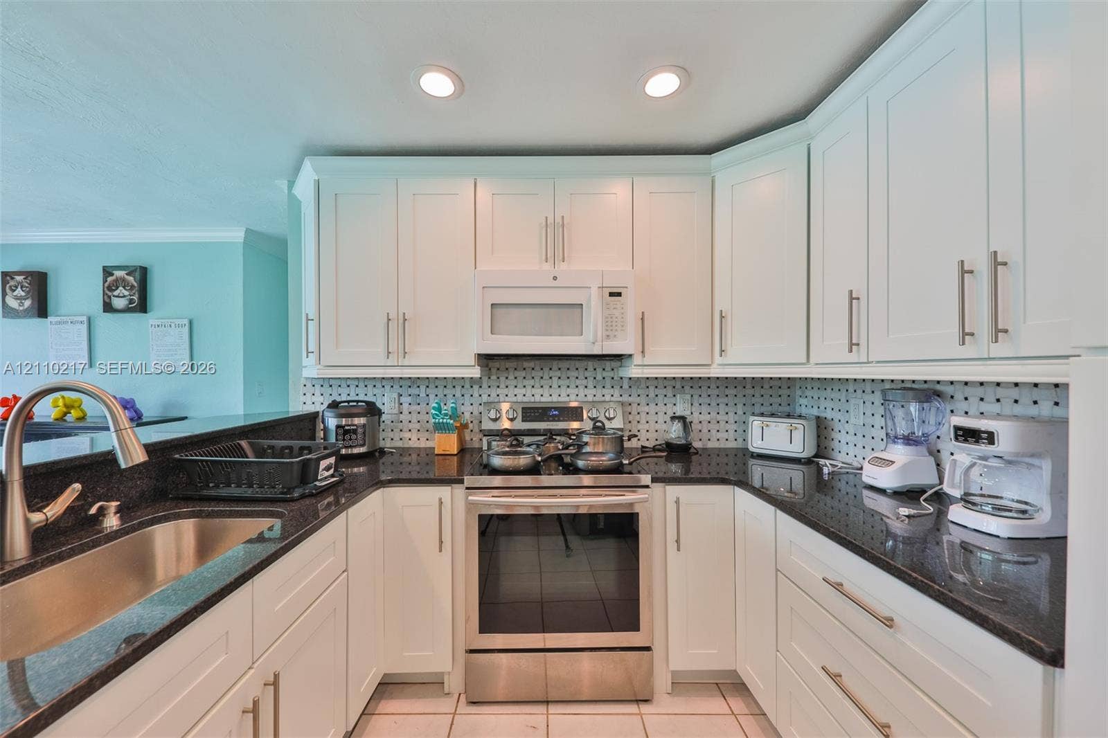 503 SW 17 Street, Cape Coral, FL 33990 Kitchen featuring white shaker-style cabinetry, dark stone countertops, stainless steel appliances, a tile backsplash, and recessed lighting