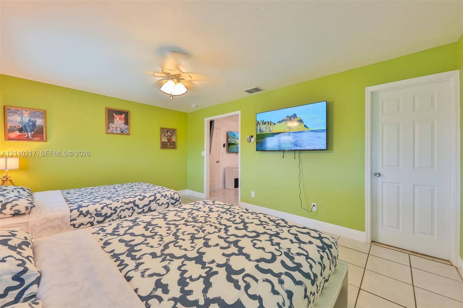 503 SW 17 Street, Cape Coral, FL 33990 Room interior featuring ceramic tile flooring, a multi-blade ceiling fan with integrated lighting, and a six-panel interior door