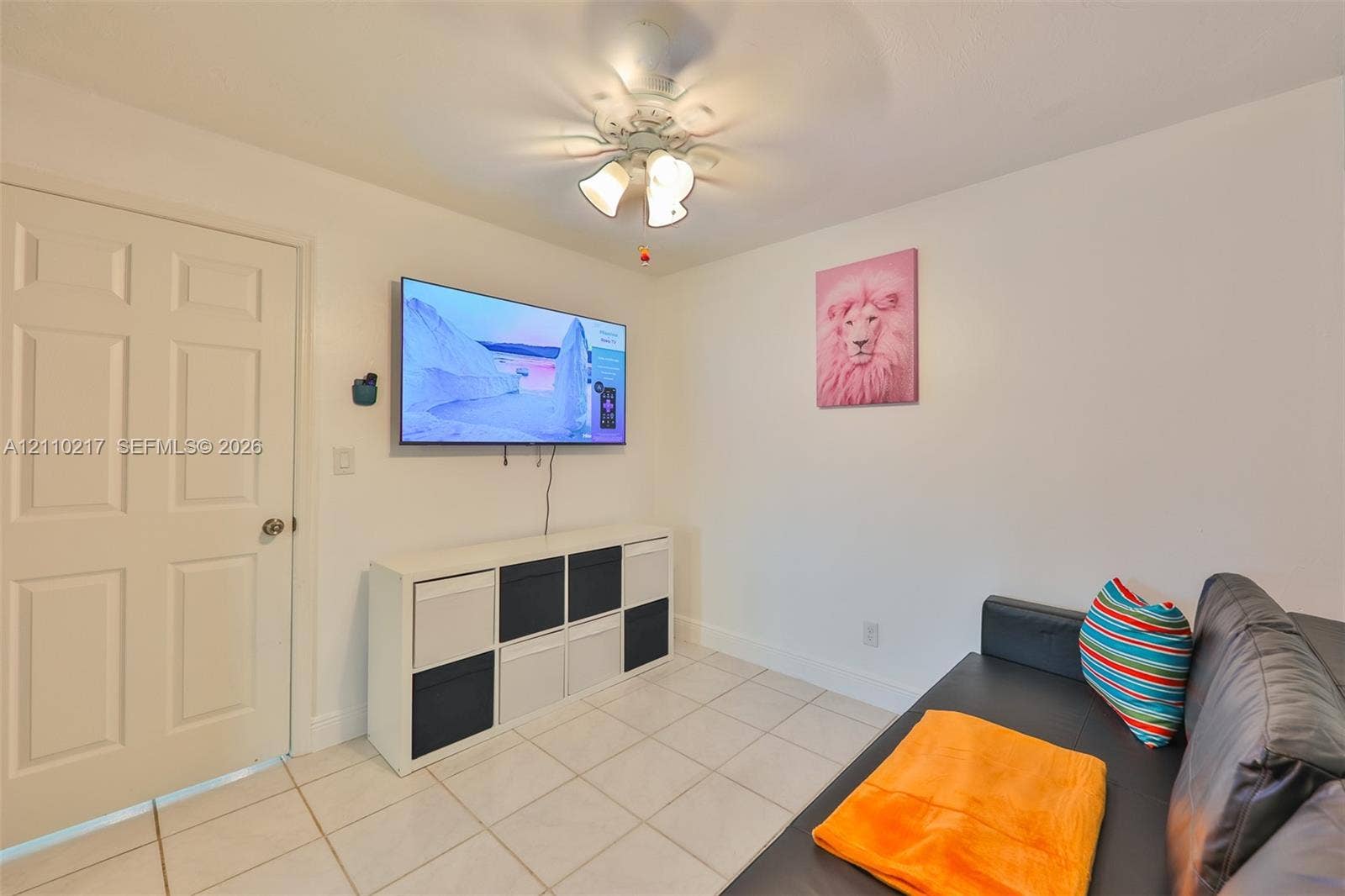 503 SW 17 Street, Cape Coral, FL 33990 Ceramic tile flooring, white six-panel interior door, and ceiling-mounted light fixture with three glass shades