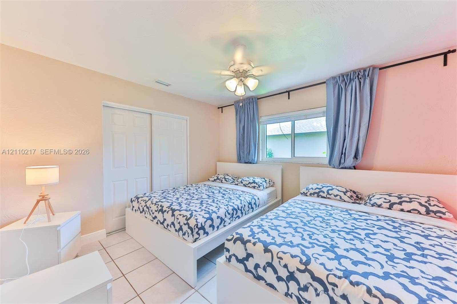 503 SW 17 Street, Cape Coral, FL 33990 Room featuring tile flooring, sliding closet doors, and a ceiling-mounted light fixture with a fan