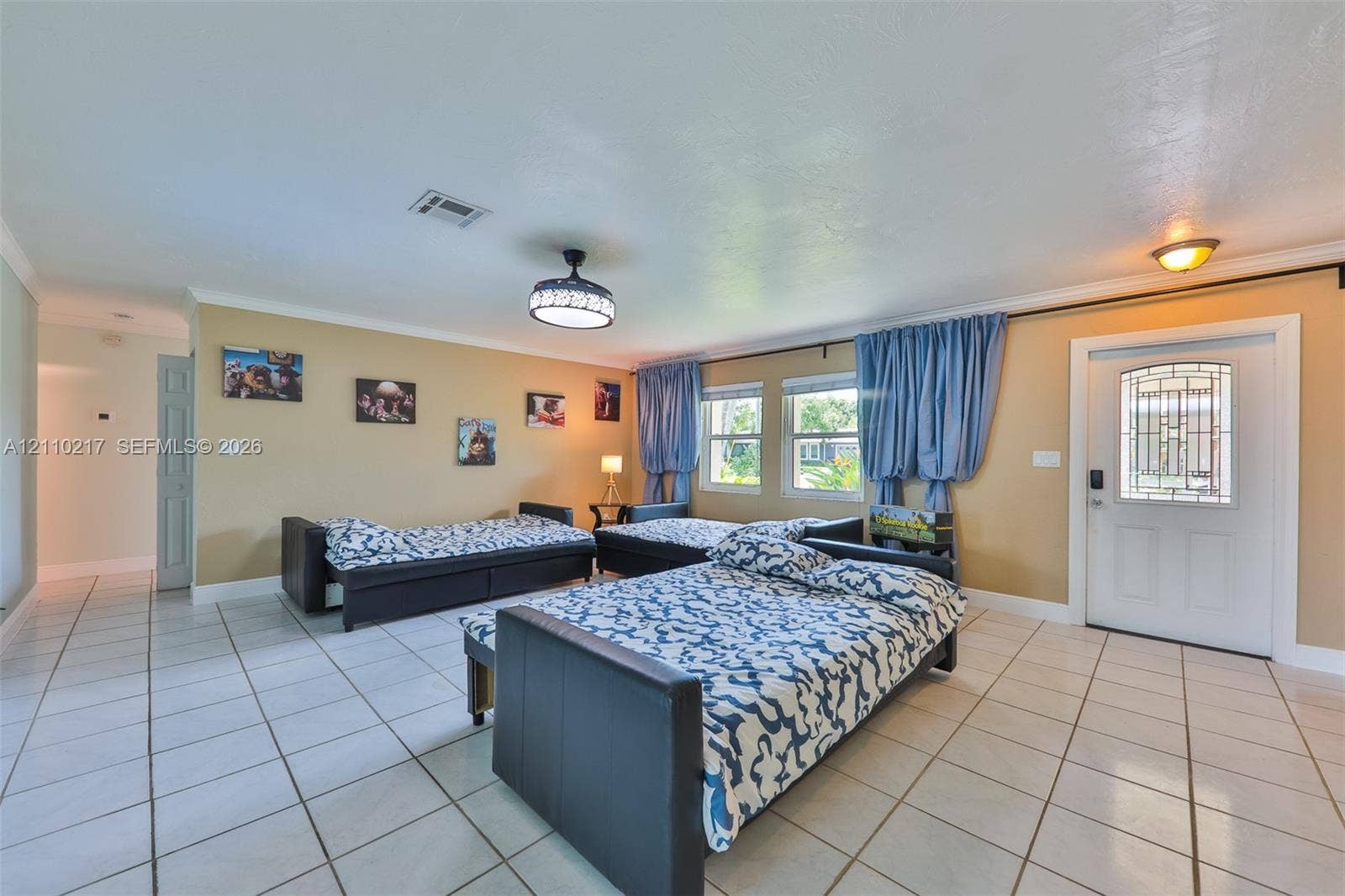503 SW 17 Street, Cape Coral, FL 33990 Ceramic tile flooring, white entry door with decorative glass inlay, ceiling-mounted light fixture, and two dual-pane windows