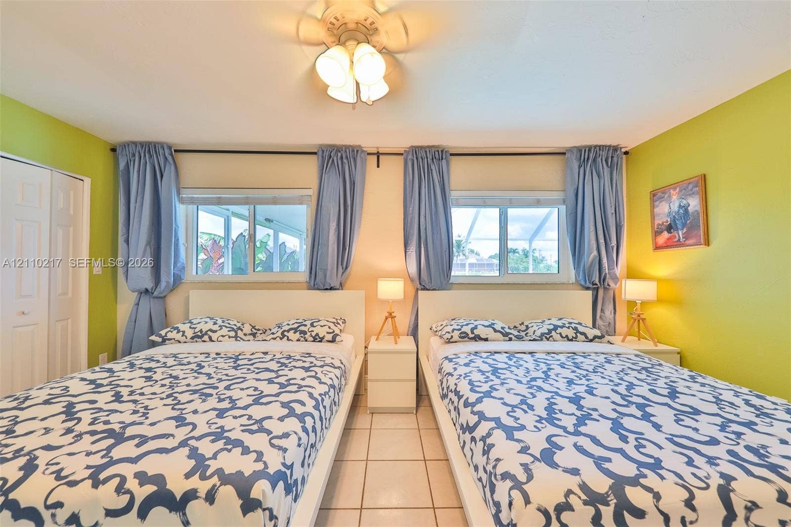 503 SW 17 Street, Cape Coral, FL 33990 Two dual-pane sliding windows, ceramic tile flooring, ceiling fan with glass-shade light fixture, and paneled closet doors