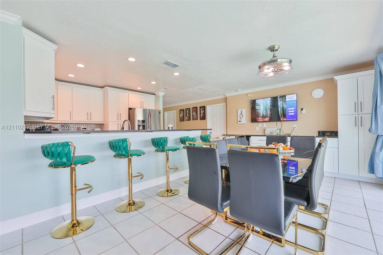 503 SW 17 Street, Cape Coral, FL 33990 Kitchen featuring white cabinetry, a breakfast bar, recessed lighting, and tile flooring