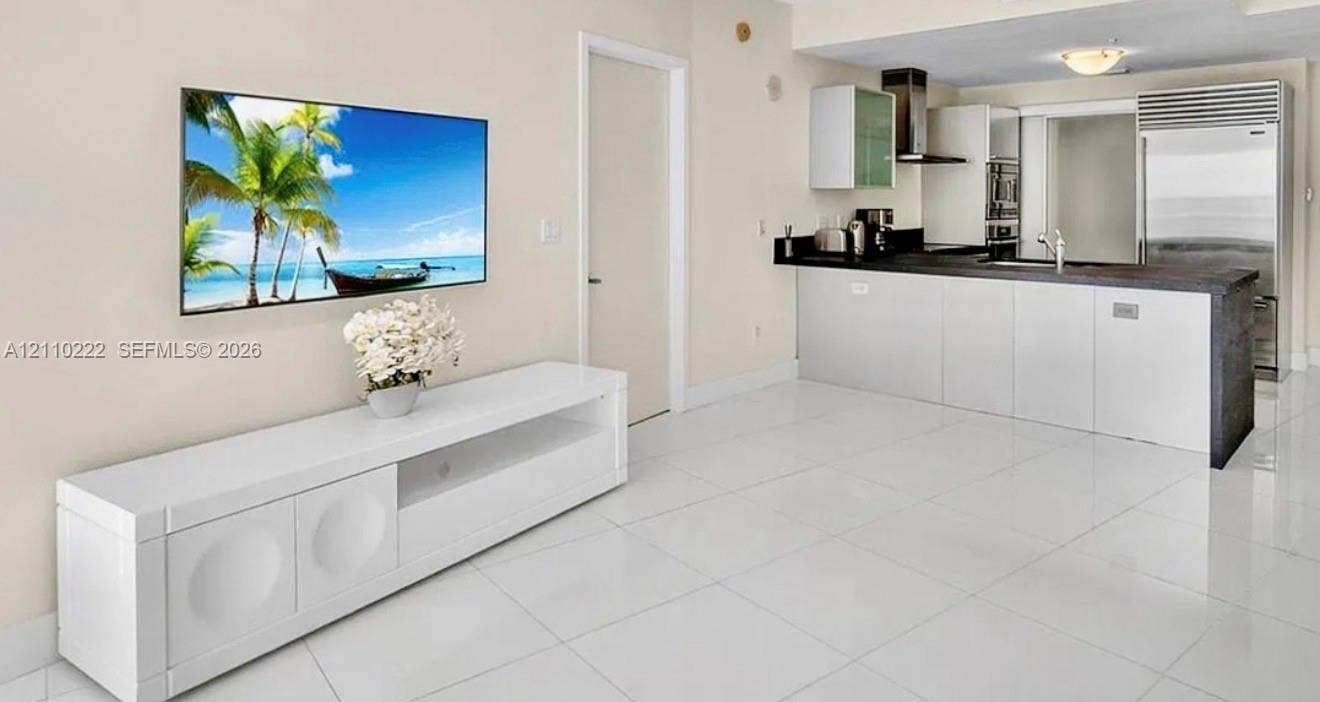 18201 Collins Avenue, #2008, Sunny Isles Beach, Sunny Isles Beach, FL 33160 Resort-style pool area featuring tiered rock formations, expansive paved decking, lush landscaping, and integrated water features