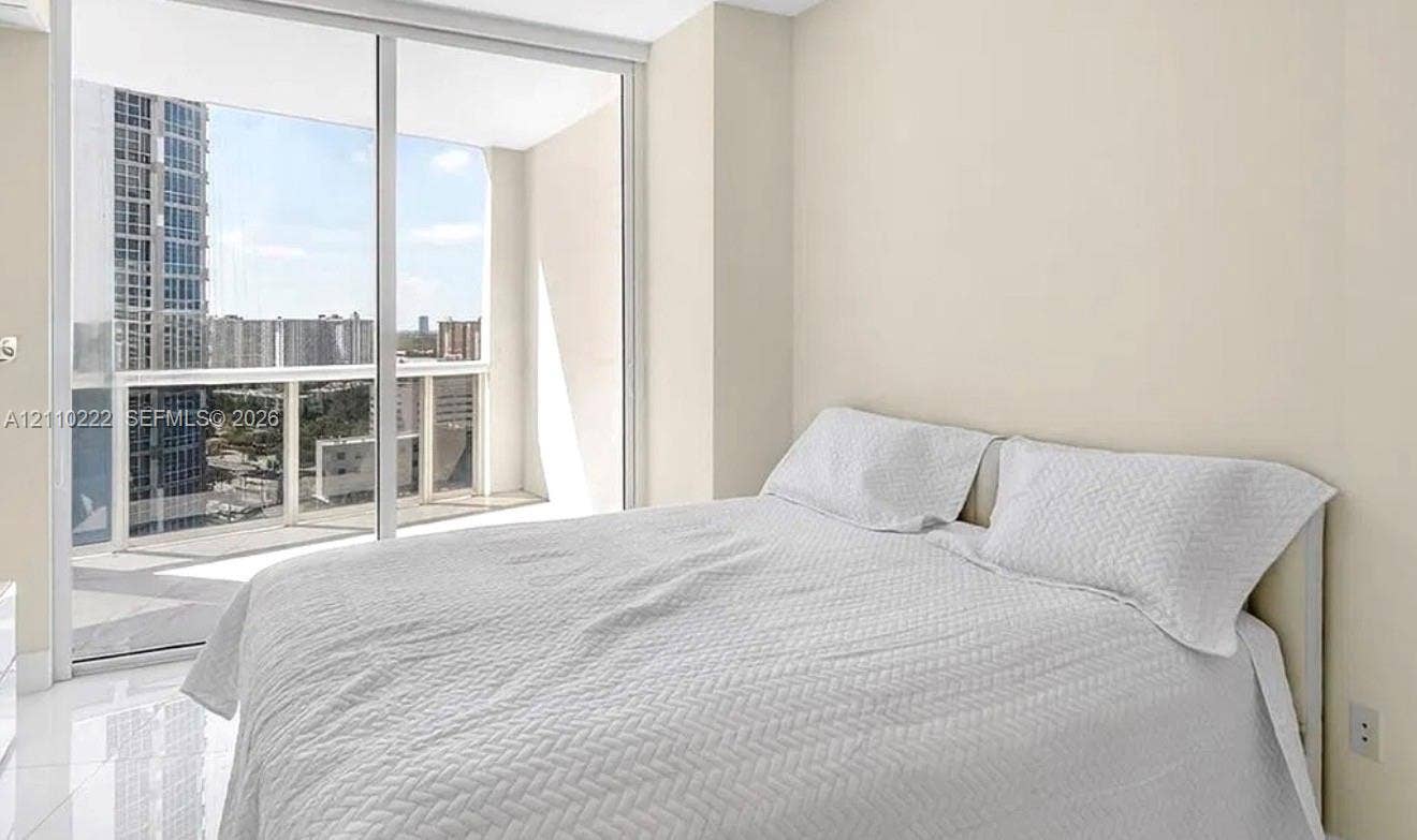 18201 Collins Avenue, #2008, Sunny Isles Beach, Sunny Isles Beach, FL 33160 Floor-to-ceiling glass sliding doors, private balcony, neutral wall palette, and polished tile flooring