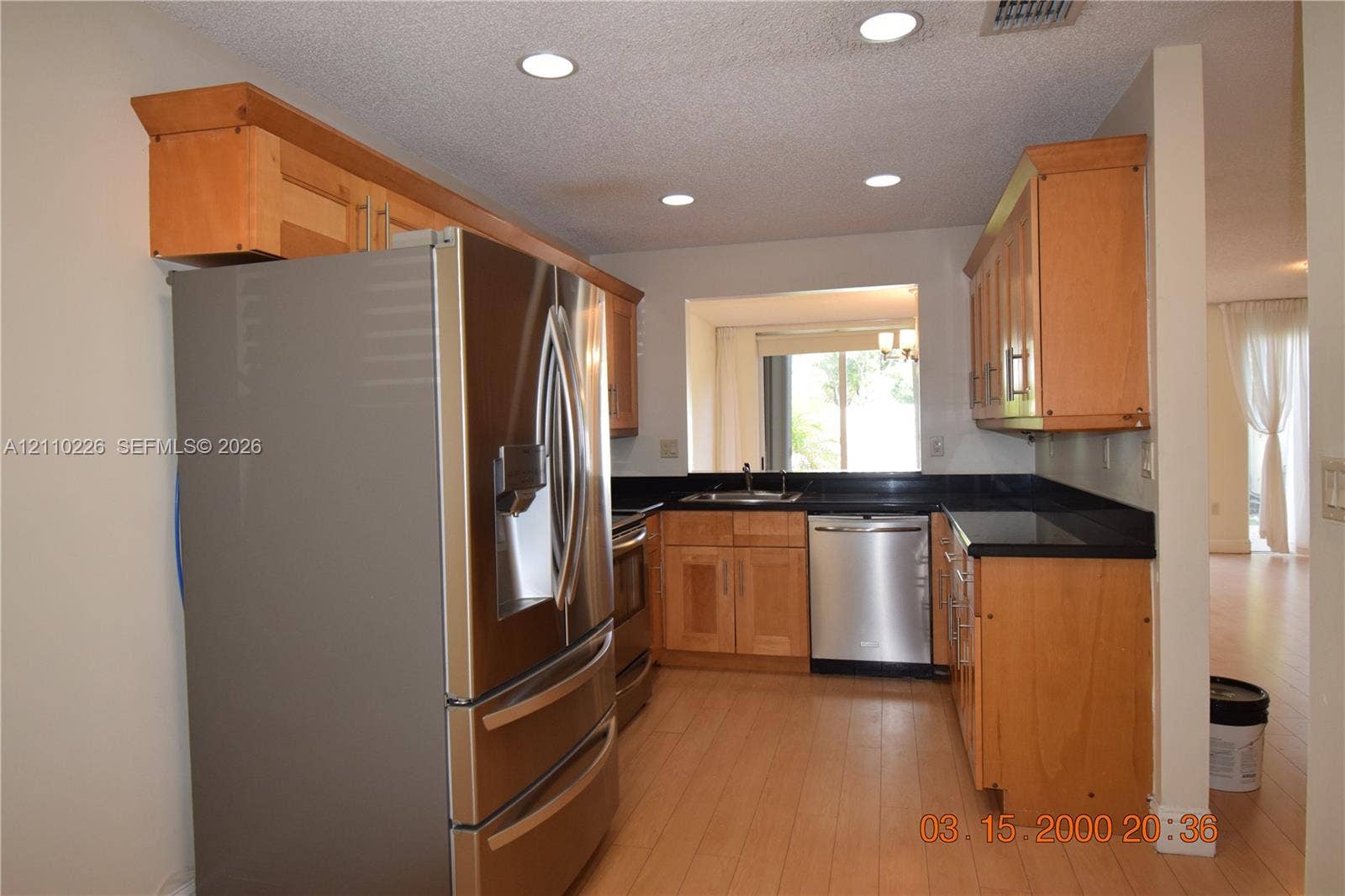 Exterior facade featuring a tile roof, covered entryway, private gated courtyard, and attached garage
