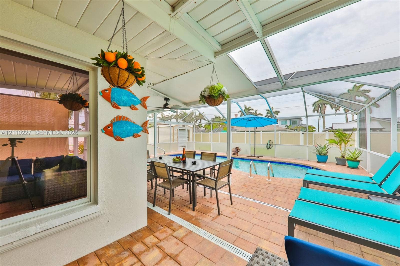 450 Bayshore Drive, Cape Coral, FL 33904 Screened lanai featuring paver flooring, a covered patio area, and an in-ground swimming pool