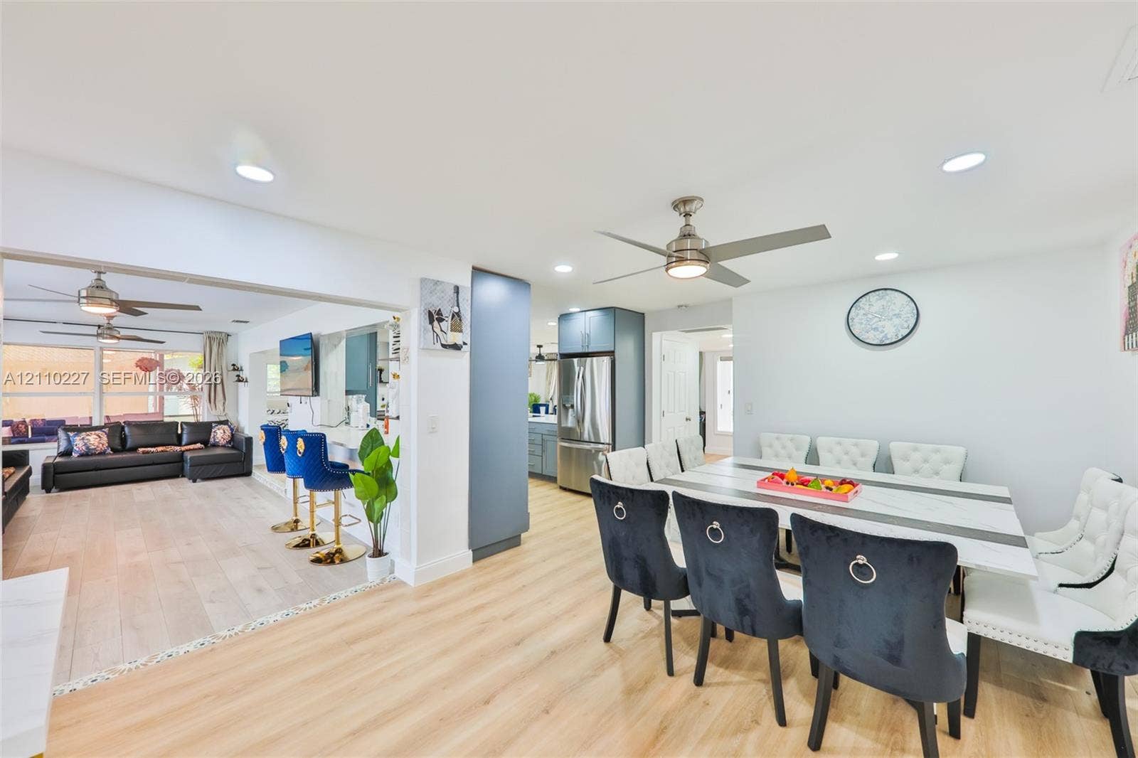 450 Bayshore Drive, Cape Coral, FL 33904 Open-concept interior featuring light wood-finish flooring, recessed lighting, matte-finish cabinetry, stainless steel kitchen appliances, and ceiling fans