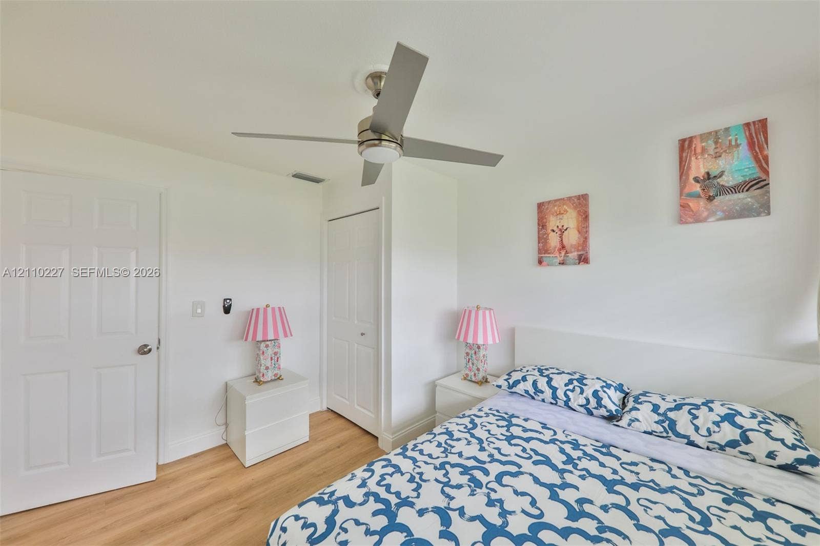 450 Bayshore Drive, Cape Coral, FL 33904 Wood-finish flooring, brushed nickel ceiling fan with integrated light fixture, and two-panel interior doors