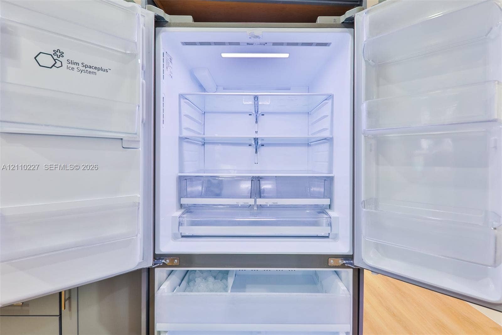 450 Bayshore Drive, Cape Coral, FL 33904 Stainless steel French door refrigerator featuring an integrated ice system, adjustable glass shelving, and humidity-controlled crisper drawers