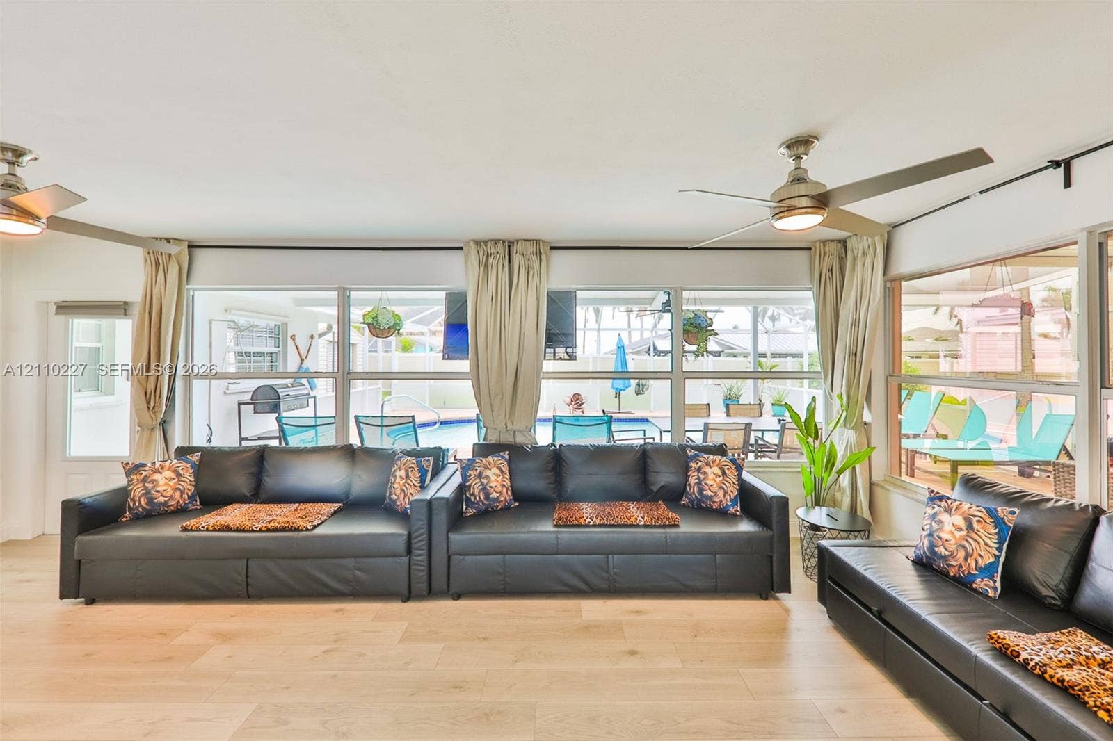 450 Bayshore Drive, Cape Coral, FL 33904 Wood-finish flooring, floor-to-ceiling windows, and dual ceiling fans