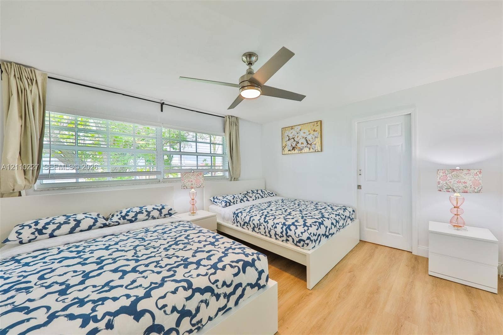 450 Bayshore Drive, Cape Coral, FL 33904 Wood-finish flooring, multi-pane windows, and a central ceiling fan with integrated lighting