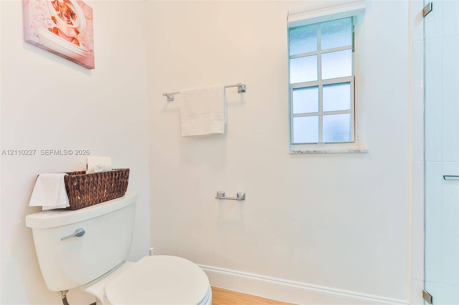 450 Bayshore Drive, Cape Coral, FL 33904 Bathroom featuring a glass-enclosed shower, multi-pane window, stone sill, and chrome hardware