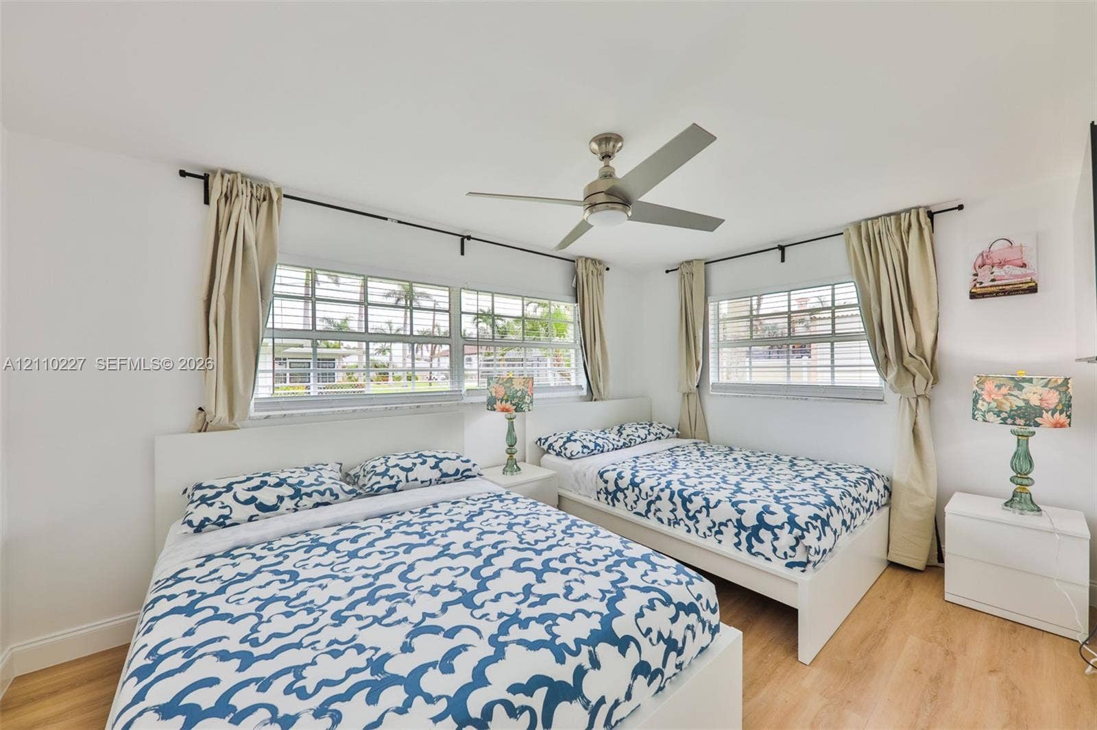 450 Bayshore Drive, Cape Coral, FL 33904 Wood-finish flooring, multi-pane windows with horizontal muntins, and a central ceiling fan