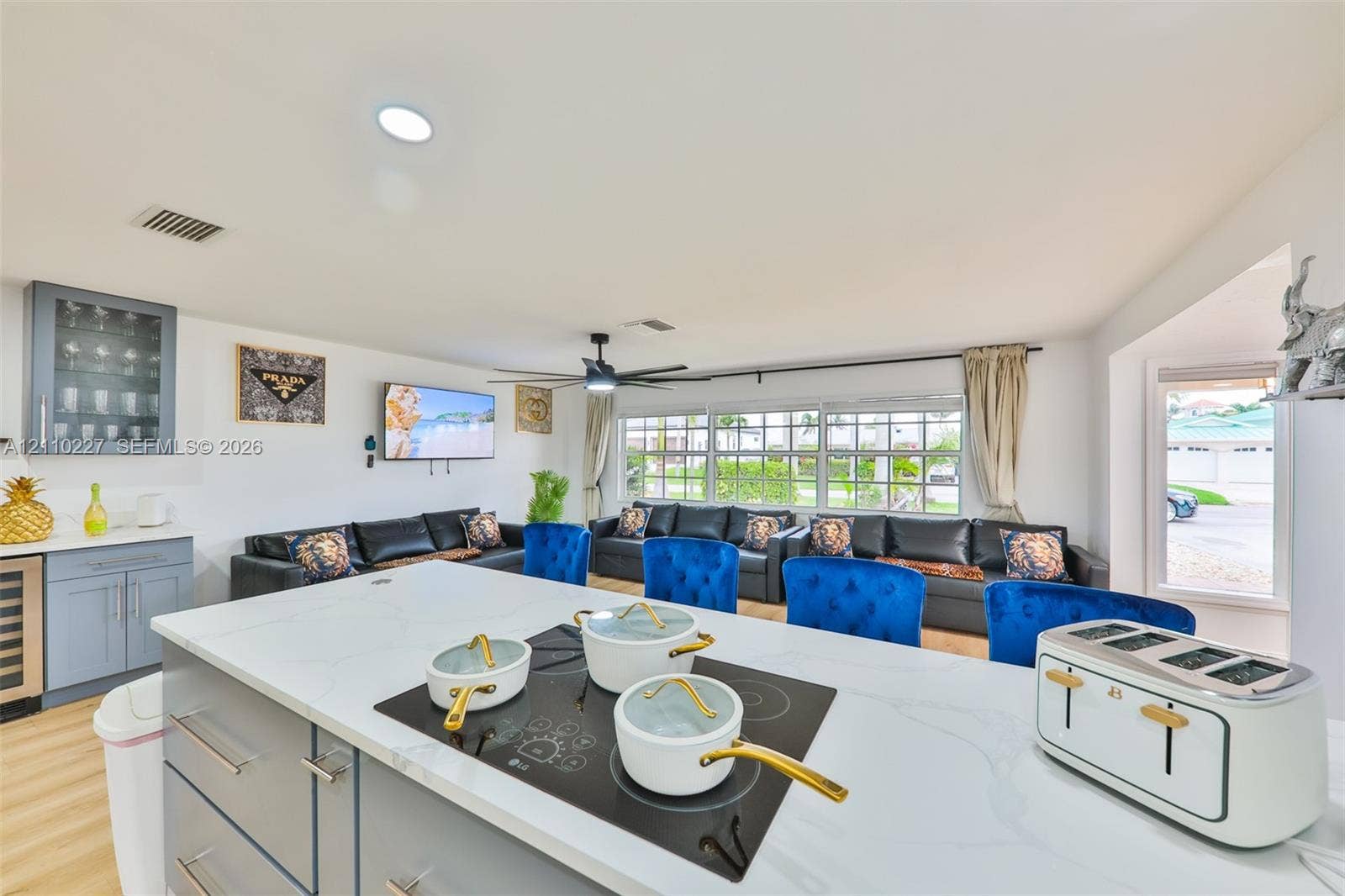 450 Bayshore Drive, Cape Coral, FL 33904 Kitchen island featuring a stone countertop, built-in cooktop, and gray cabinetry