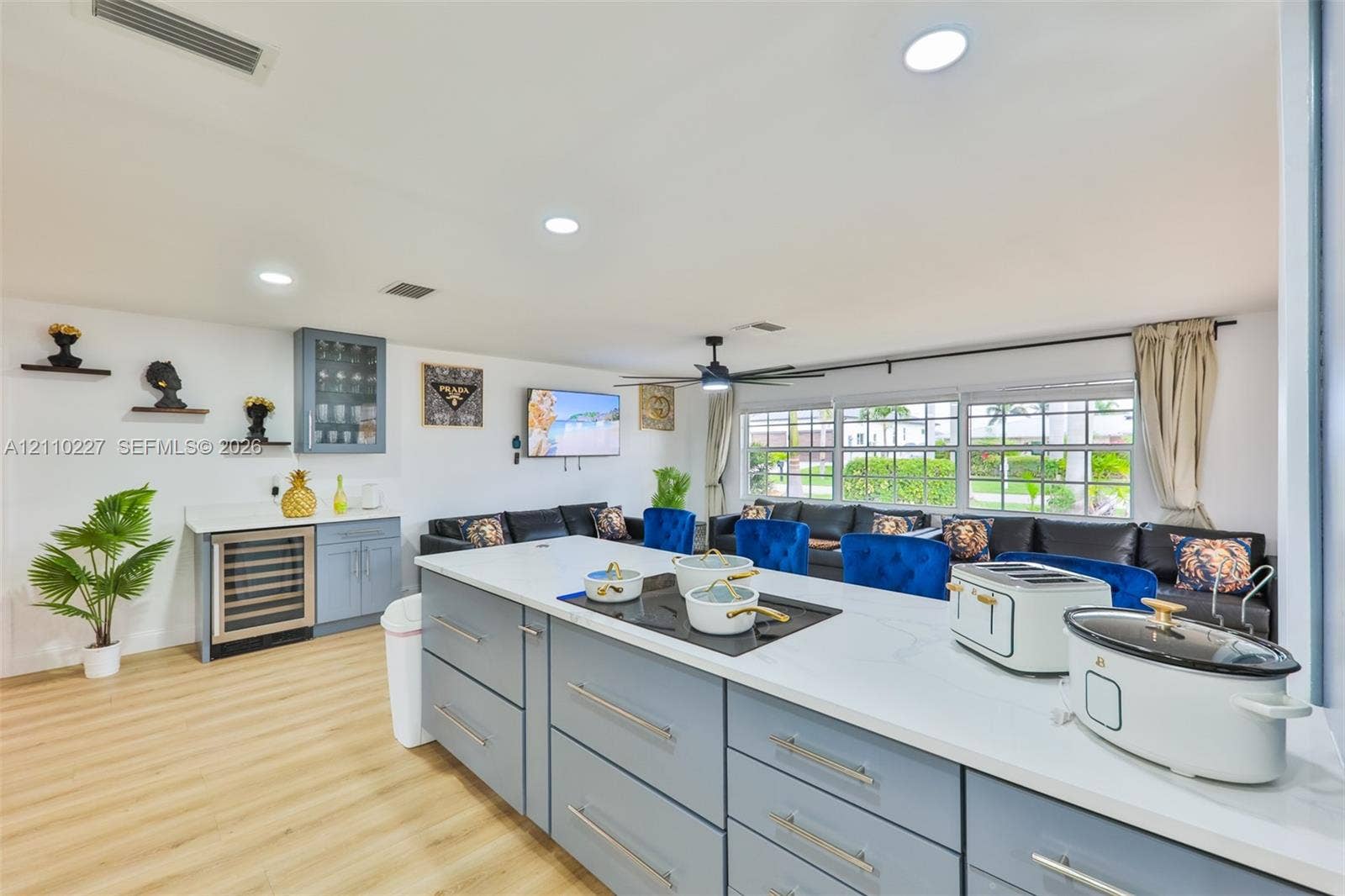 450 Bayshore Drive, Cape Coral, FL 33904 Kitchen featuring light blue cabinetry, stone-finish countertops, built-in under-counter beverage refrigerator, recessed lighting, and wood-finish flooring