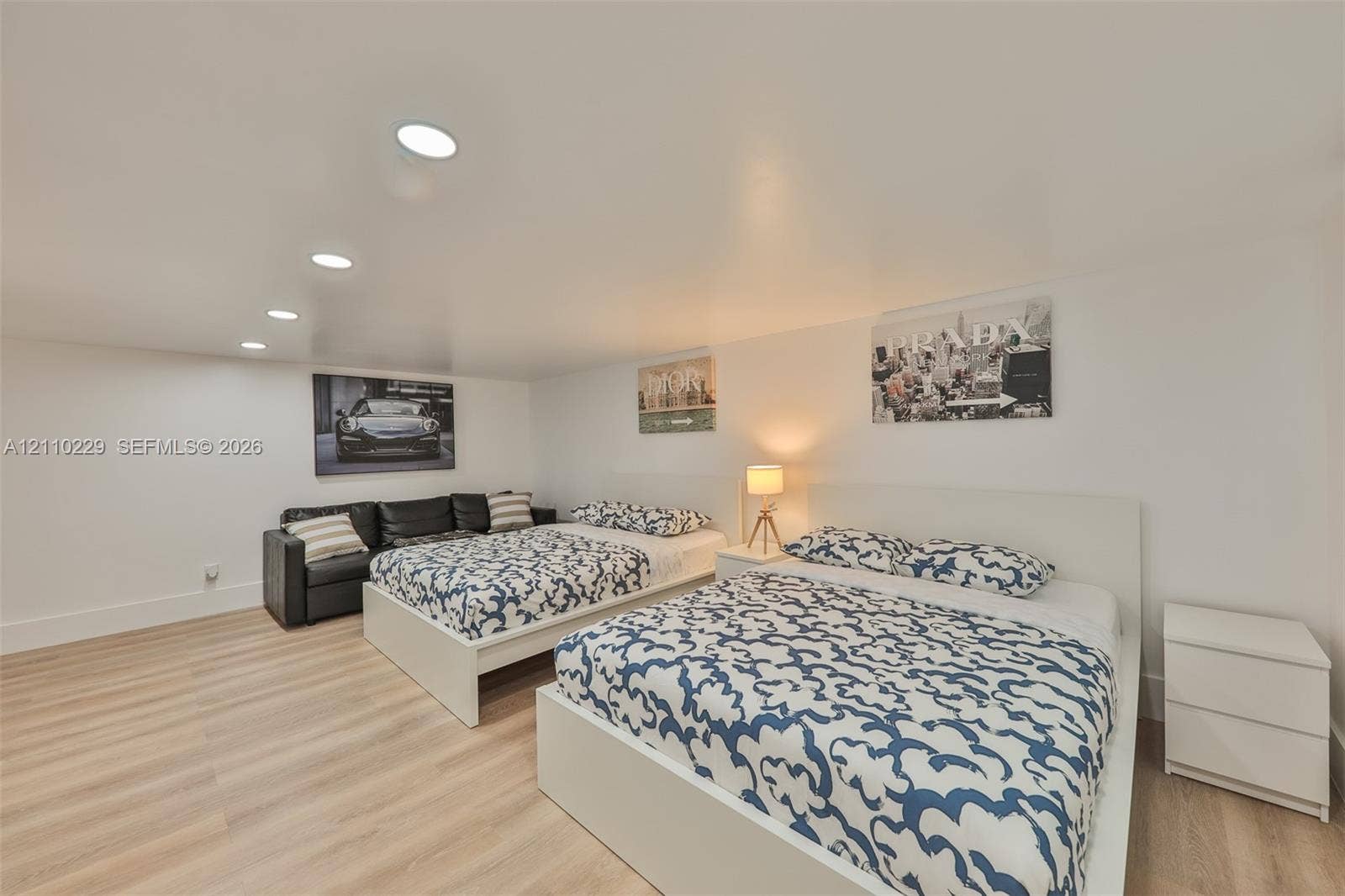 Interior space featuring light-toned wood-finish flooring, crisp neutral wall paint, and recessed ceiling lighting