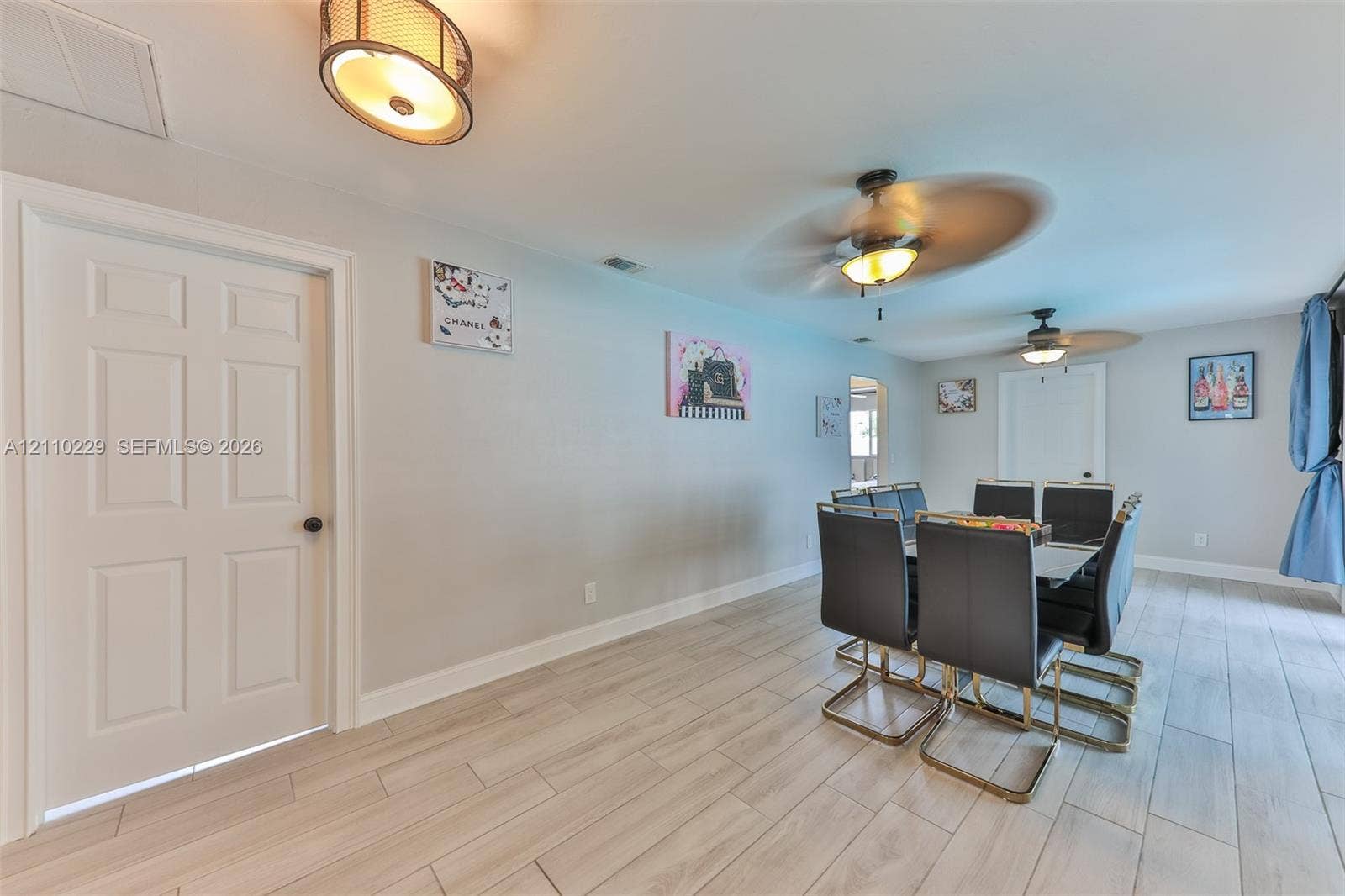 Neutral wall-finish, light-toned wood-finish flooring, recessed ceiling lighting, and dual ceiling fans