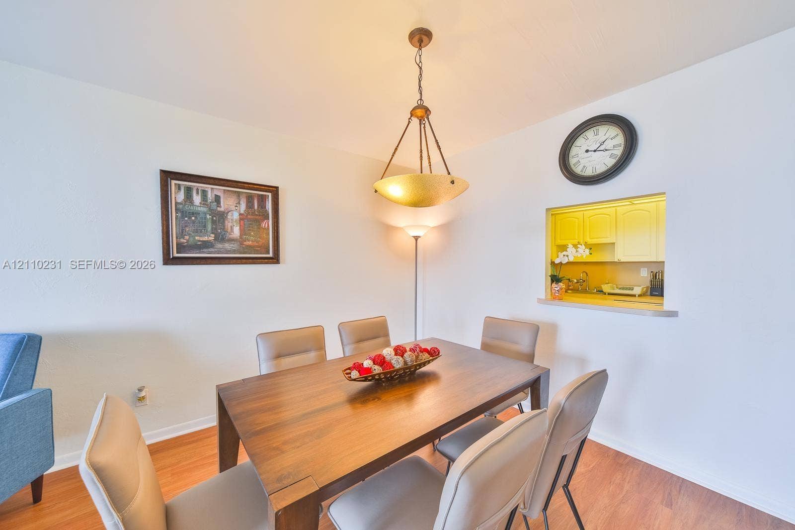 19370 Collins Avenue, #622, Sunny Isles Beach, FL 33160 Wood-finish flooring, metal inverted pendant light fixture, and interior pass-through window opening to cabinetry