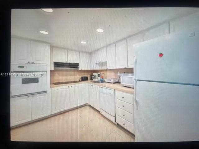 19370 Collins Avenue, #622, Sunny Isles Beach, FL 33160 Kitchen featuring white cabinetry, integrated wall oven, dishwasher, neutral countertops, and recessed lighting
