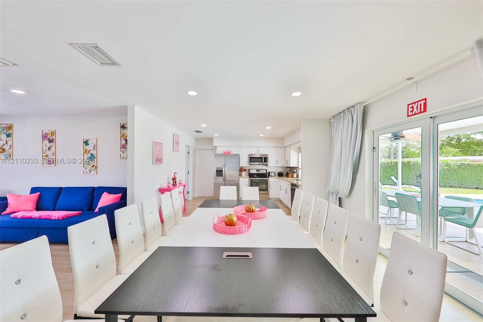 614 S Crescent Drive, Hollywood, FL 33021 Open-concept interior featuring recessed lighting, light-toned flooring, and white kitchen cabinetry with stainless steel appliances