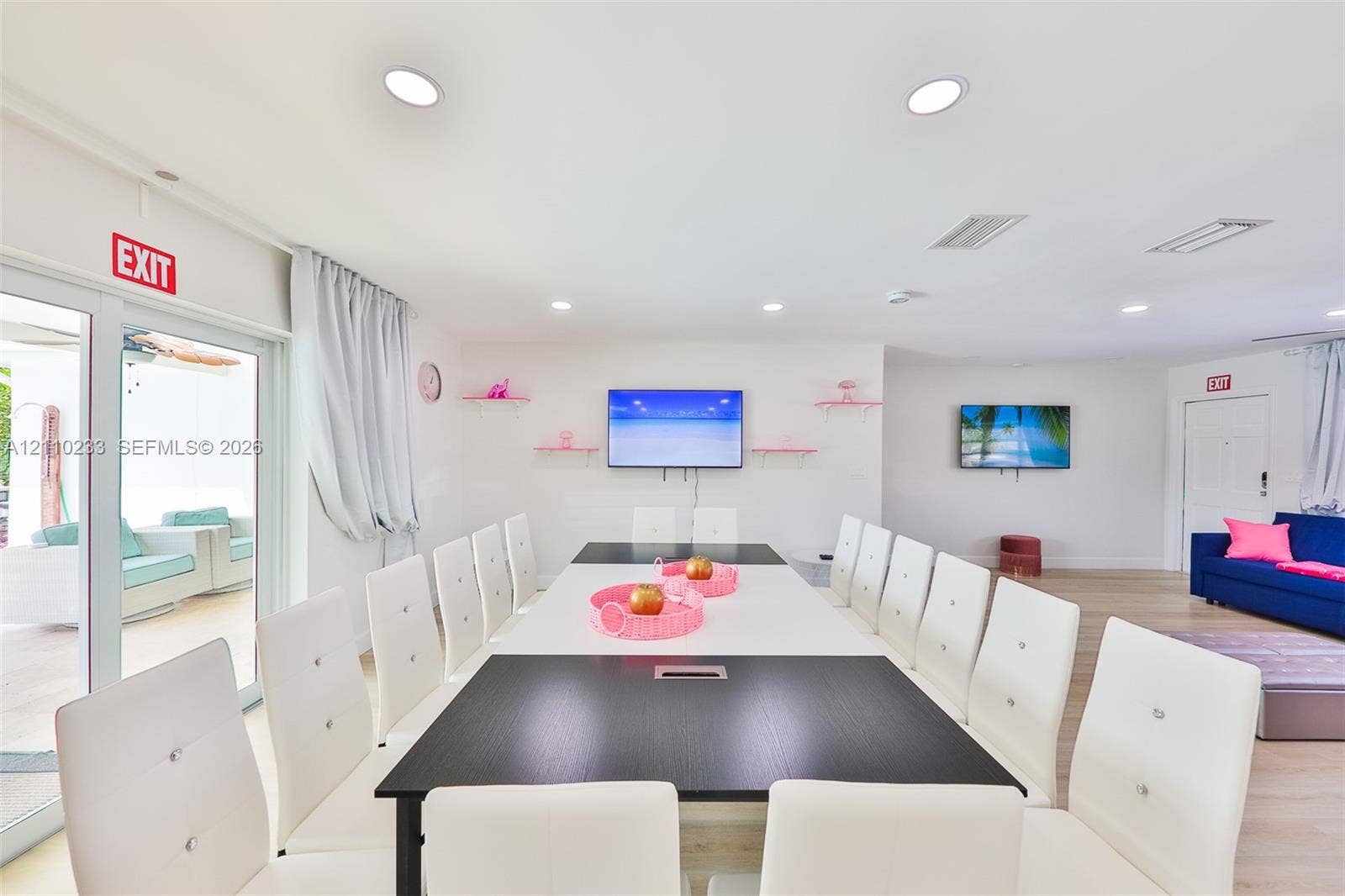 614 S Crescent Drive, Hollywood, FL 33021 Open-concept space featuring recessed ceiling lighting, light-toned wood-finish flooring, and glass sliding doors