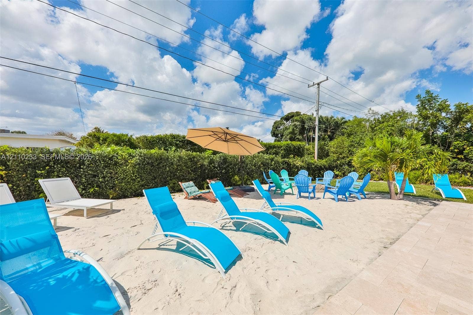 614 S Crescent Drive, Hollywood, FL 33021 Outdoor space featuring a sand-covered ground, paver patio, and natural hedge perimeter