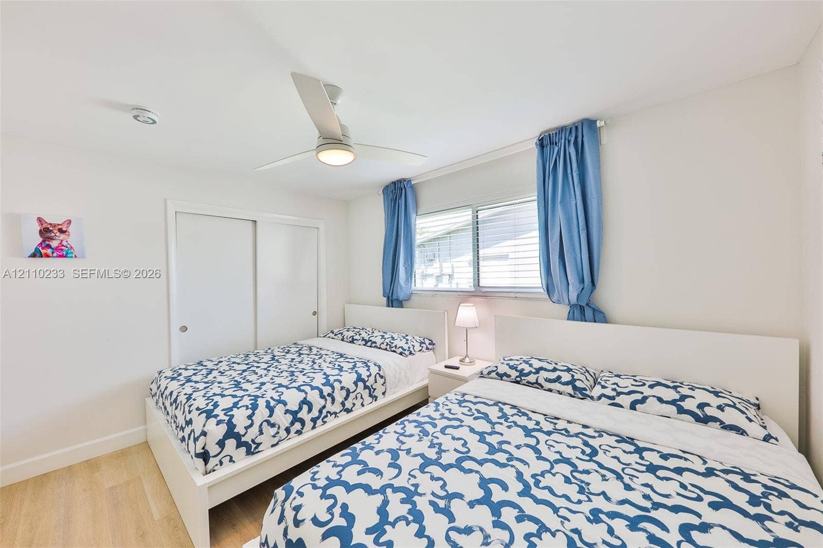614 S Crescent Drive, Hollywood, FL 33021 Wood-finish flooring, sliding door closet, and ceiling fan with integrated lighting