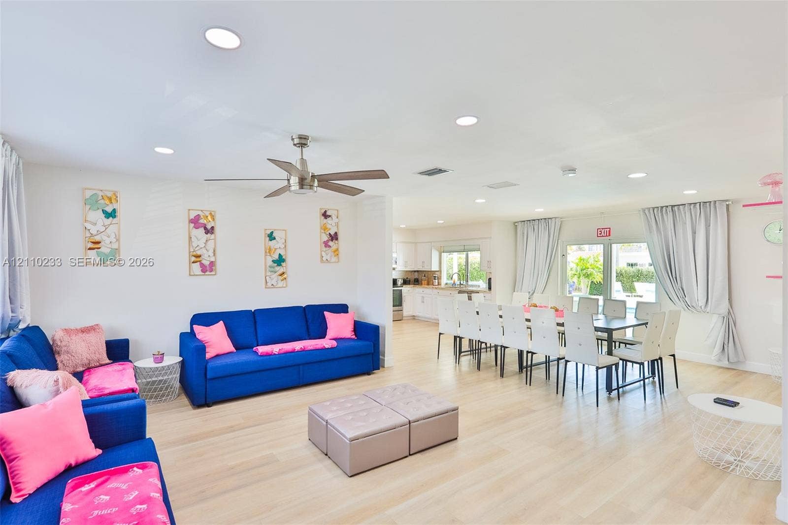614 S Crescent Drive, Hollywood, FL 33021 Open-concept floor plan featuring light-toned wood-finish flooring, recessed lighting, and a brushed-nickel ceiling fan
