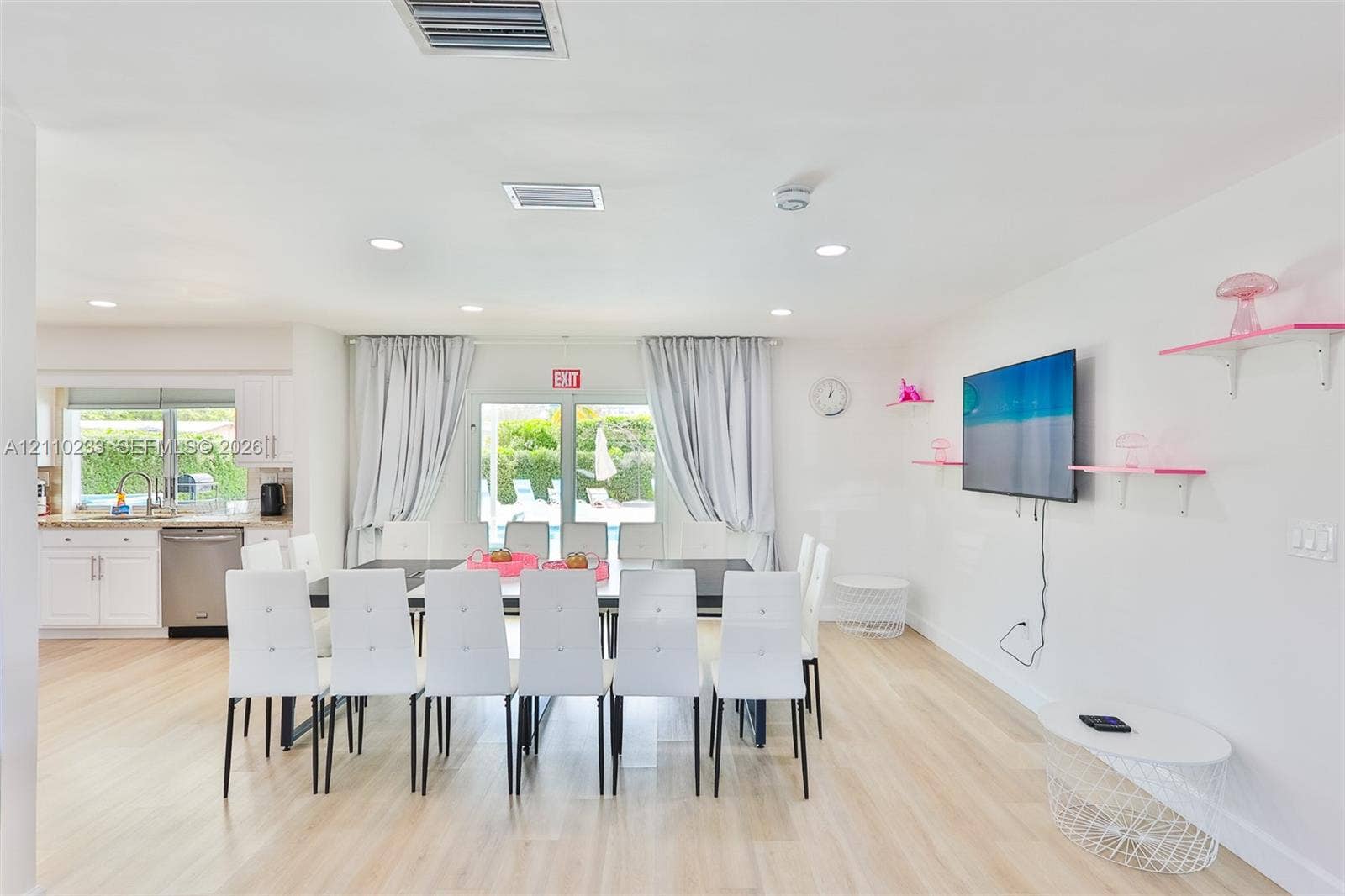 614 S Crescent Drive, Hollywood, FL 33021 Open-concept interior featuring wood-finish flooring, recessed lighting, and white cabinetry