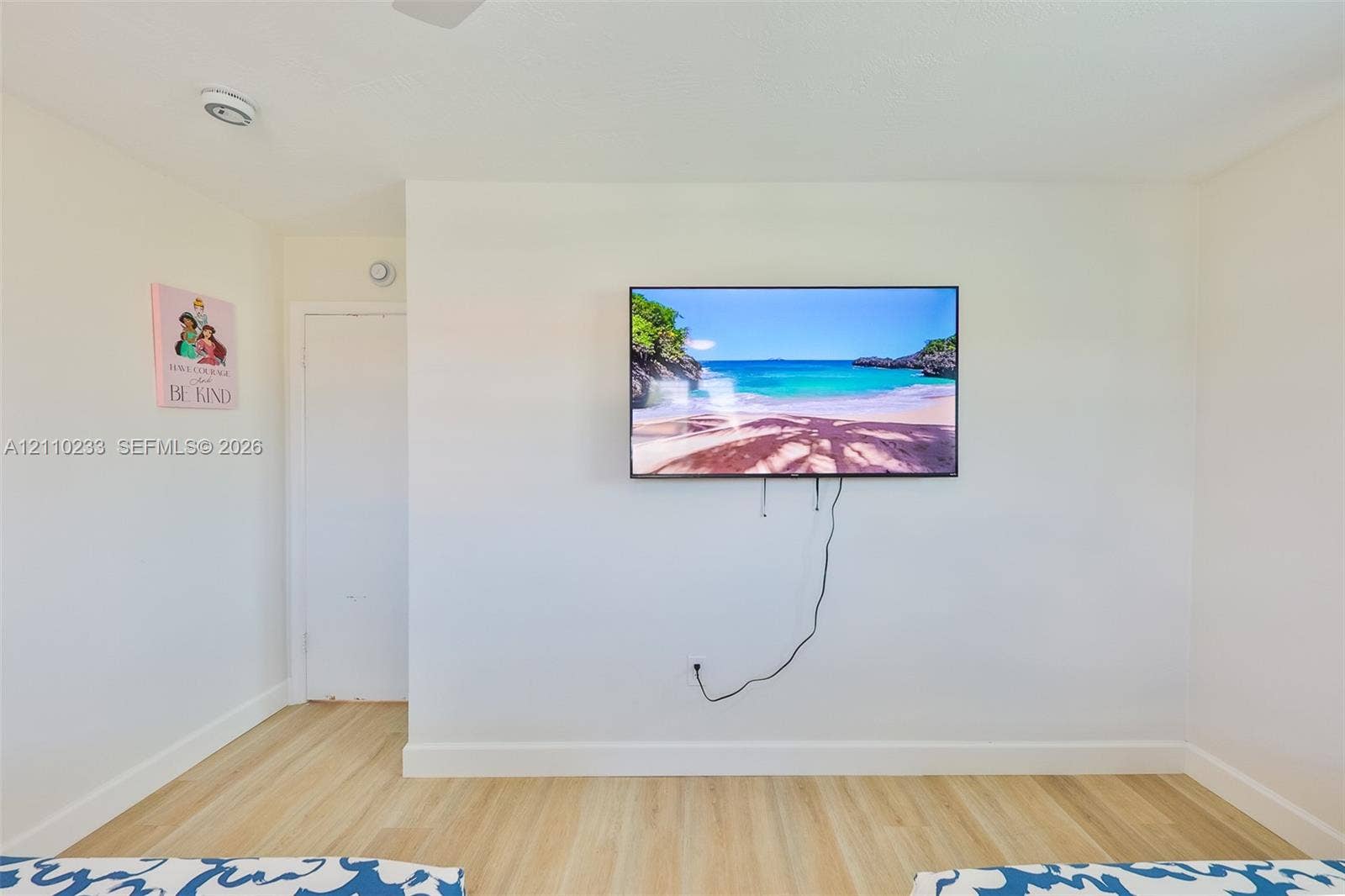 614 S Crescent Drive, Hollywood, FL 33021 Neutral-toned interior wall featuring wood-finish flooring and a white swing-style door