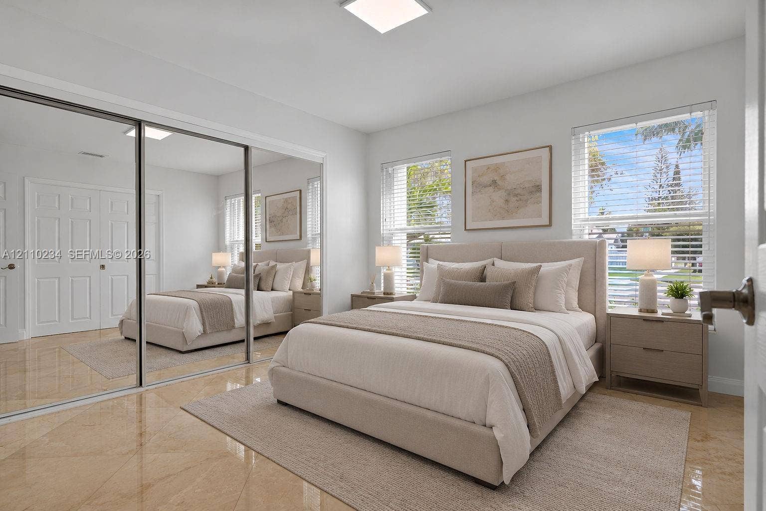 Bedroom featuring polished tile flooring, full-wall sliding mirrored closet doors, recessed ceiling lighting, and multiple windows with horizontal blinds