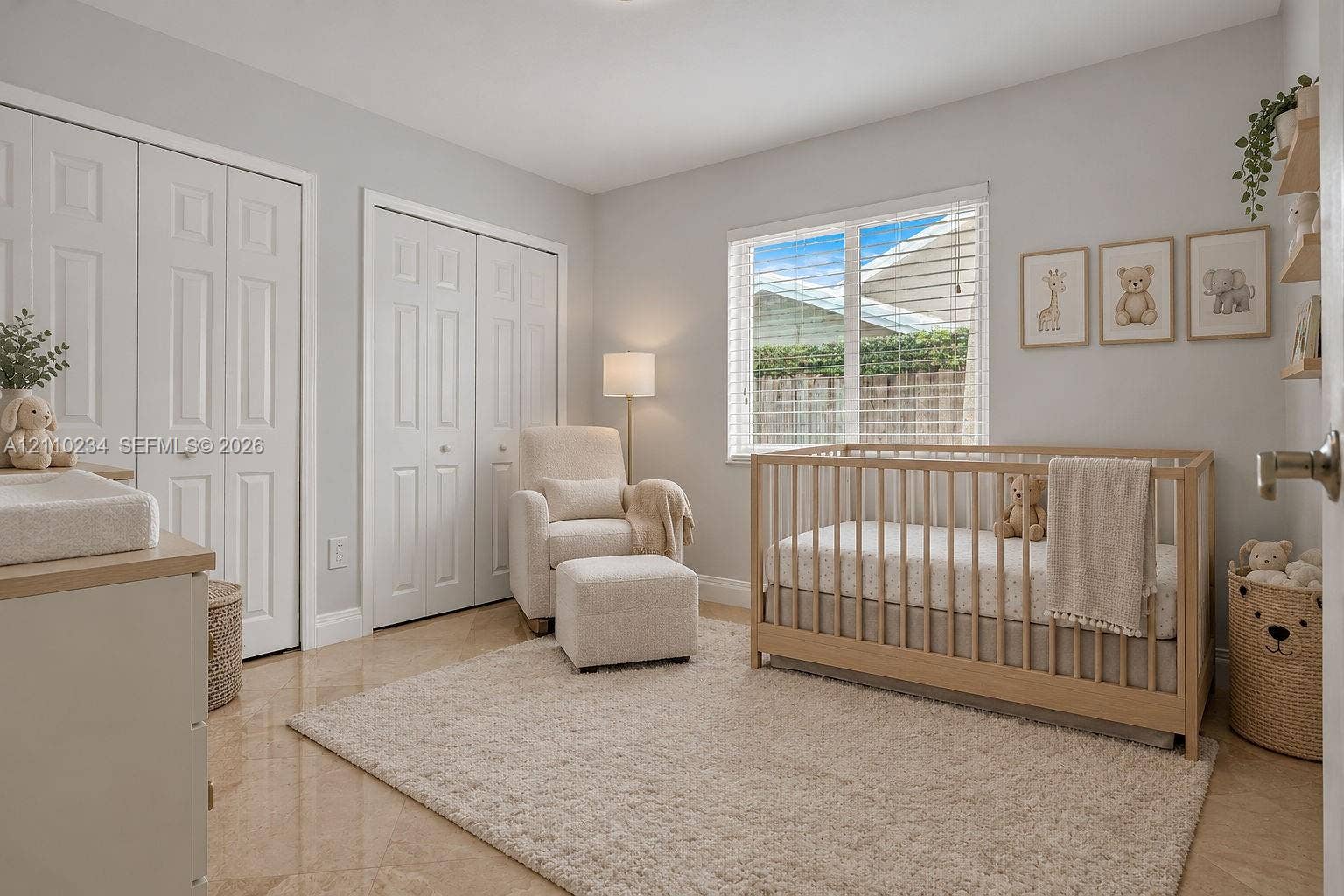 Neutral-toned interior featuring glossy tile flooring, dual bi-fold closet doors, and a multi-pane window with integrated blinds