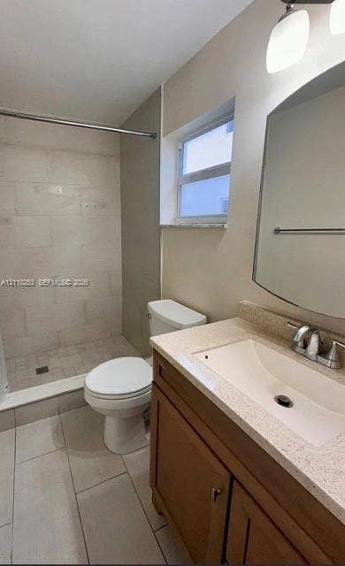 Bathroom featuring a wood-finish vanity with a stone-composite countertop, integrated sink, wall-mounted mirror, and a walk-in shower with large-format tile surround and matte-finish floor tiling