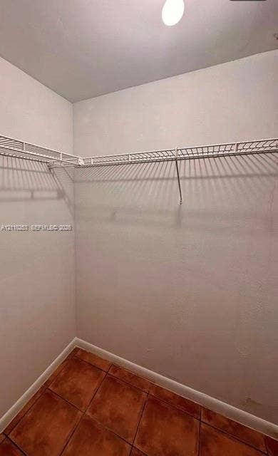 Storage area featuring tile flooring and white wire shelving