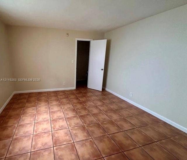 Neutral-toned walls and large-format ceramic tile flooring