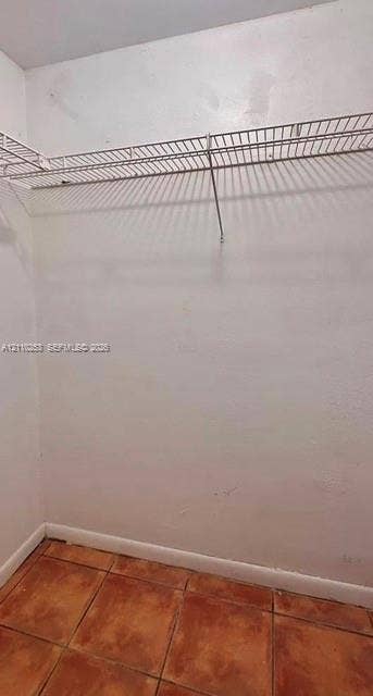Storage area featuring ceramic tile flooring and white wire shelving