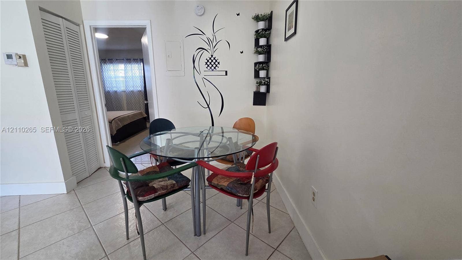 415 NE 2nd Street, #106, Hallandale Beach, Hallandale Beach, FL 33009 Neutral-toned ceramic tile flooring and white bi-fold closet doors