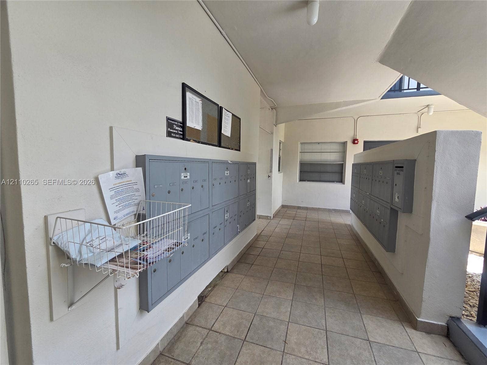 415 NE 2nd Street, #106, Hallandale Beach, Hallandale Beach, FL 33009 Common area featuring neutral ceramic tile flooring and integrated gray metal mailbox banks