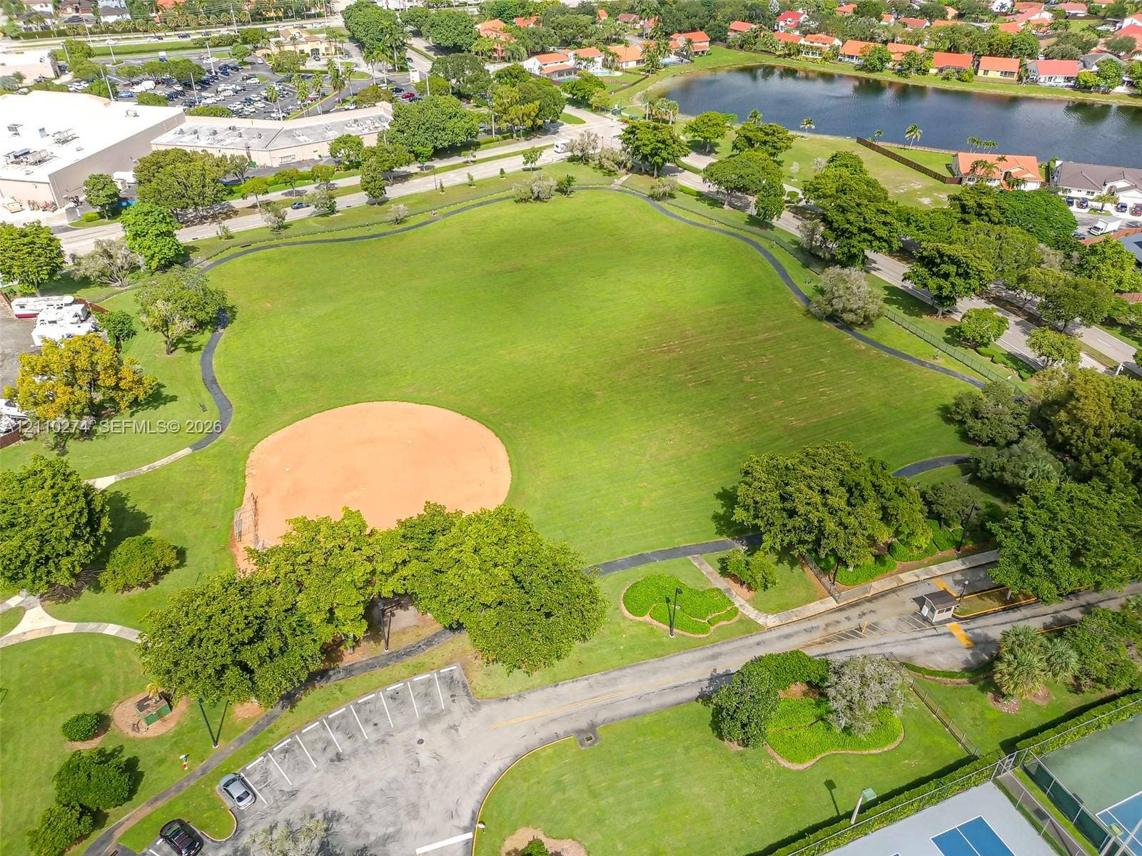 14955 SW 49th Lane, #5E, Miami, FL 33185 Expansive recreational park grounds featuring a baseball diamond, paved walking paths, paved surface parking, and mature trees